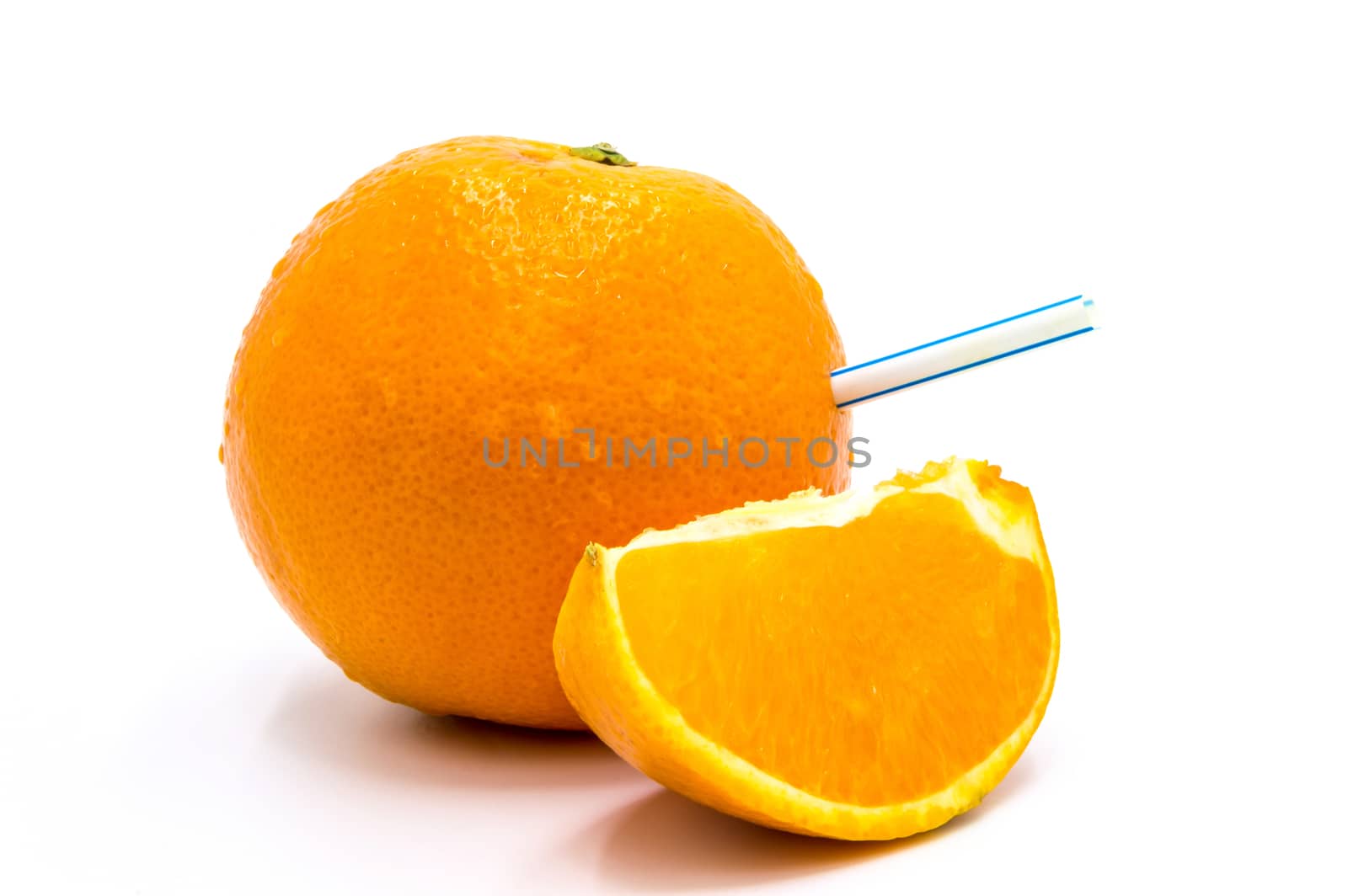 Close-up of drinking straw on an orange wedge against on a white background