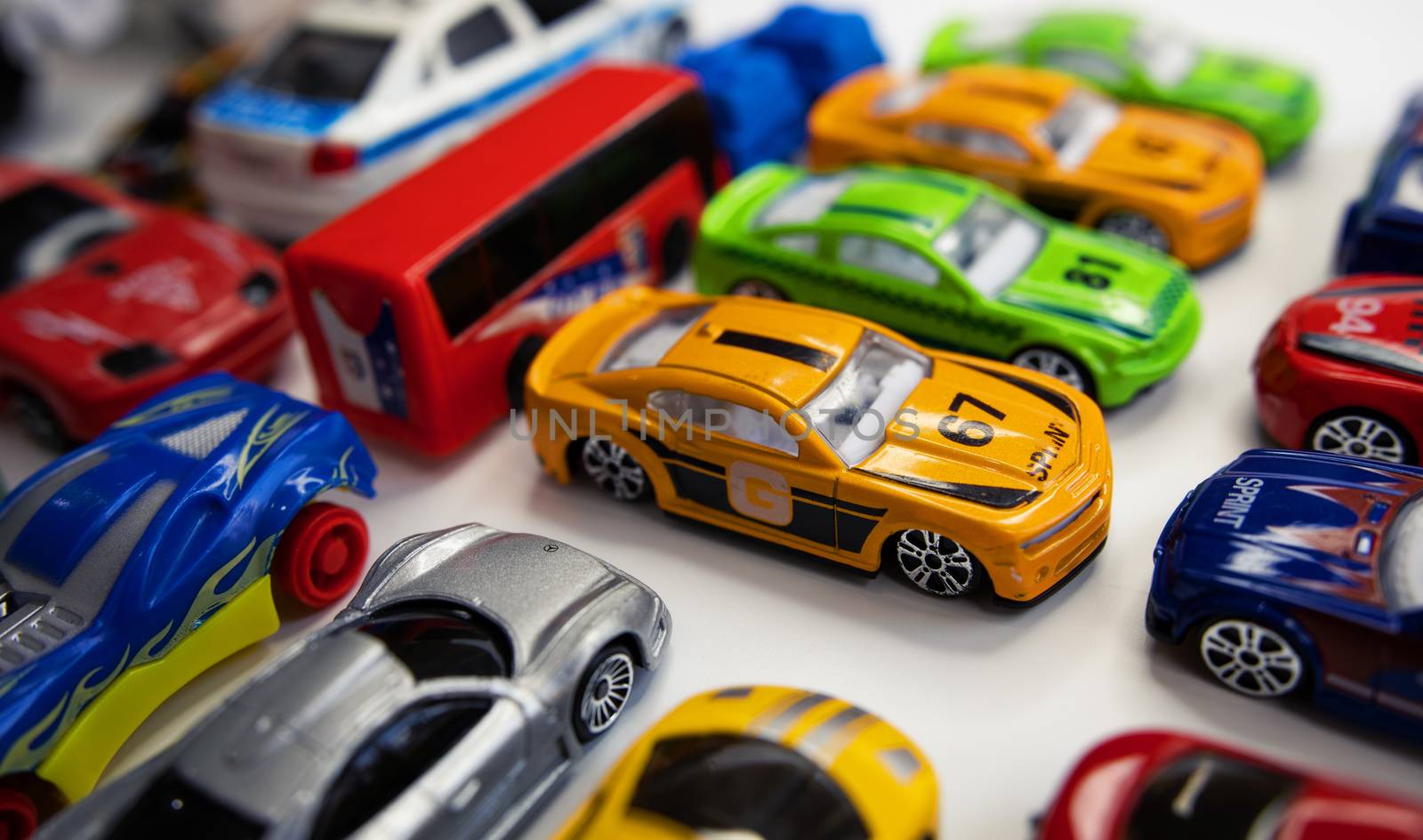 Toy cars of different colors arranged on a white background. by tadeush89