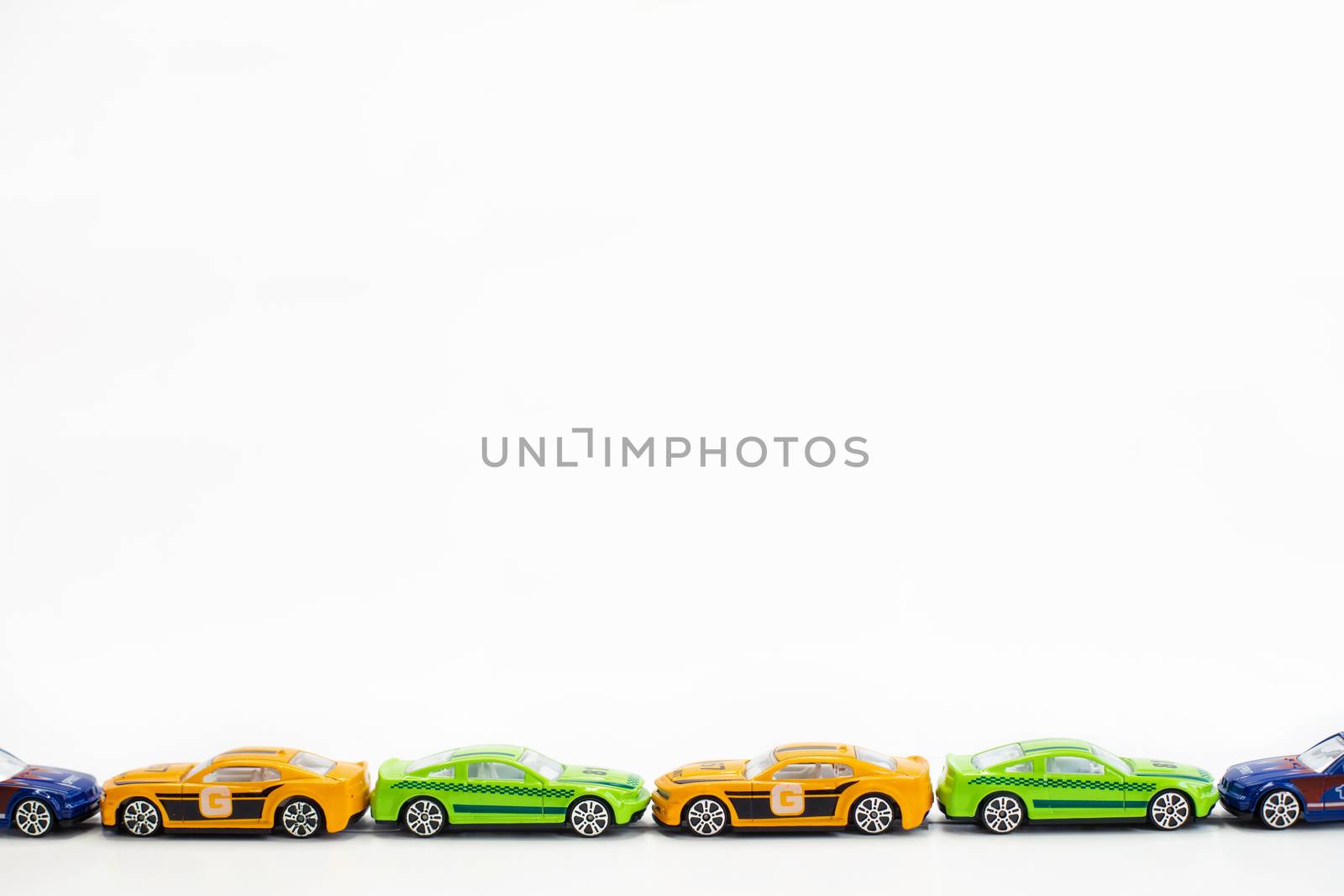 Toy cars of different colors arranged on a white background.