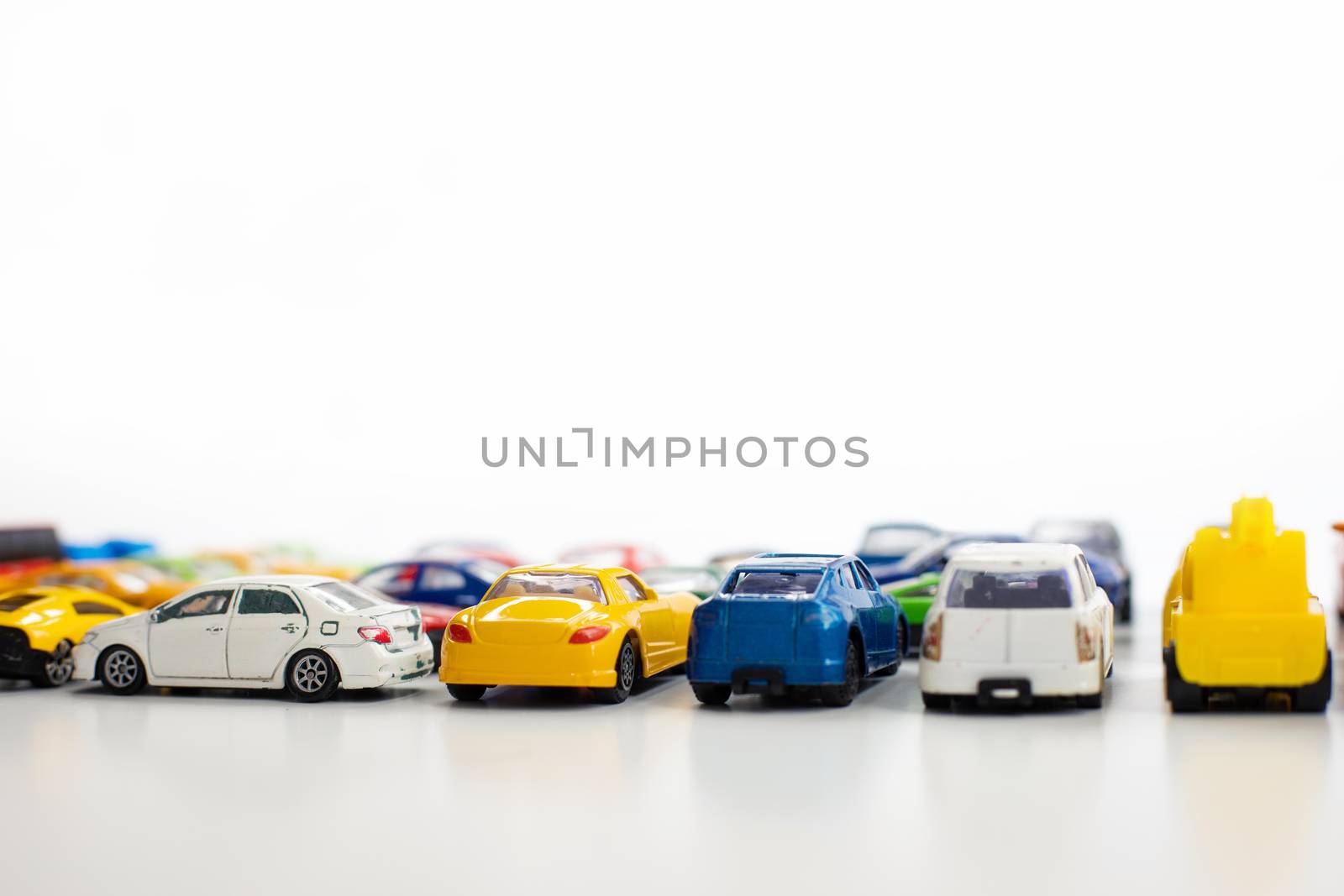 Toy cars of different colors arranged on a white background. by tadeush89