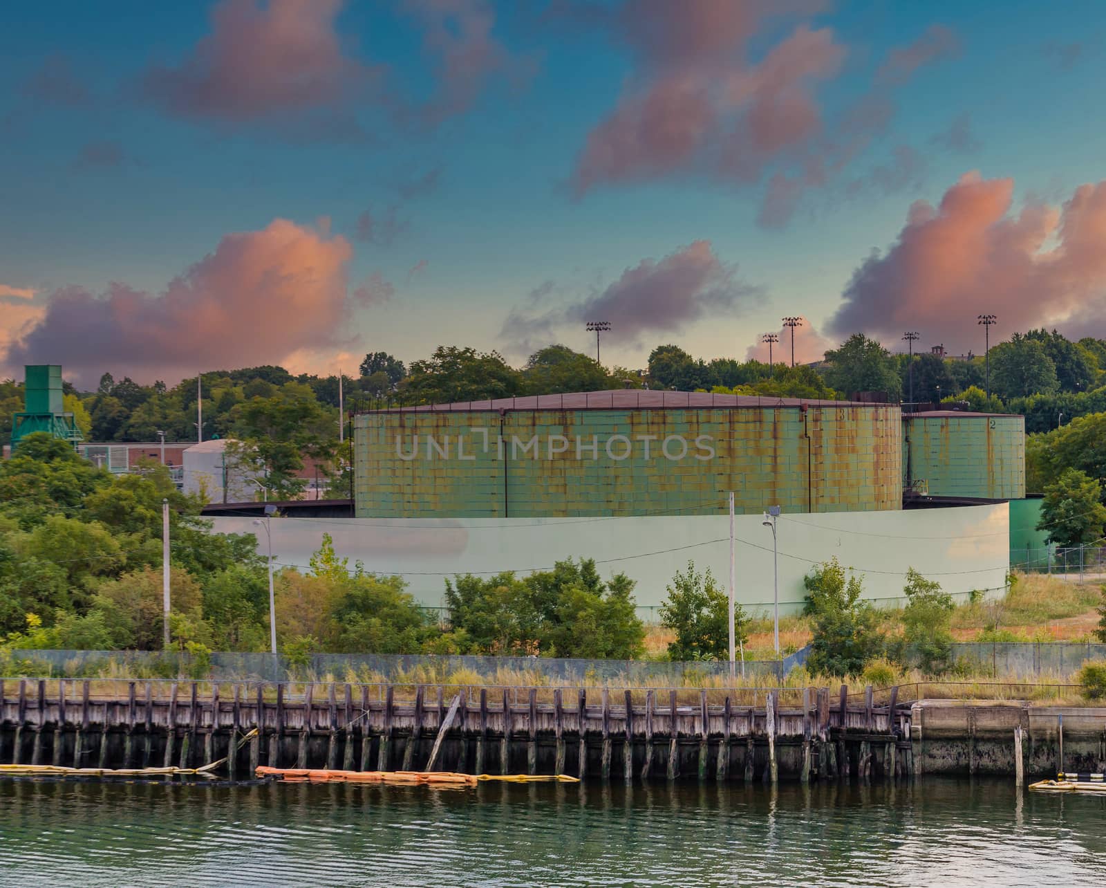 Green Industrial Tanks at Edge of Harbor by dbvirago