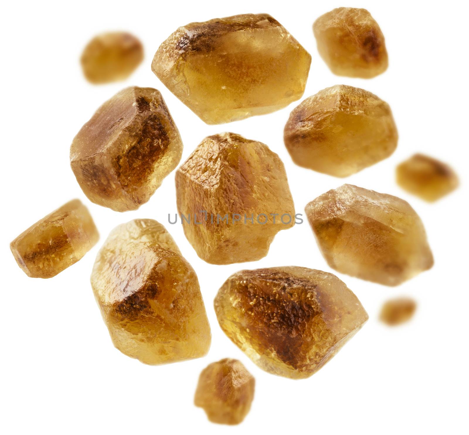 Caramelized sugar levitates on a white background.