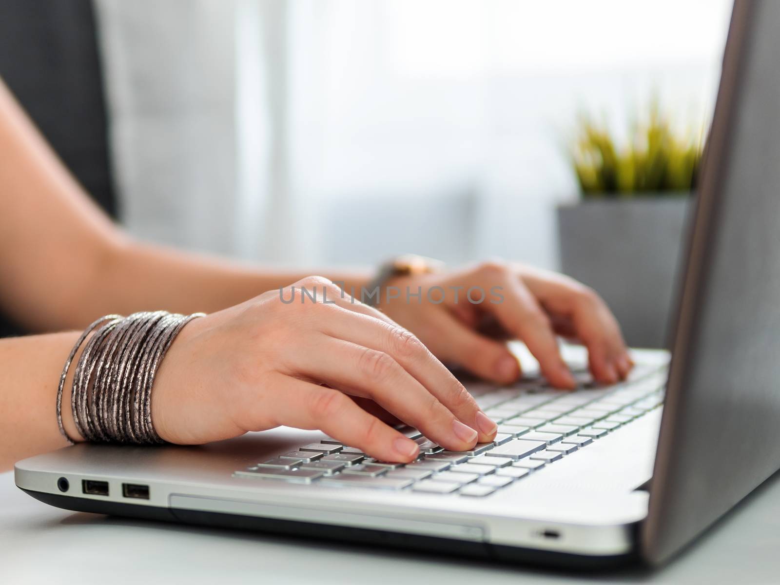 Working from home, contractor, freelance, social media, social marketing concept. Close-up woman's hands typing on laptop keyboard at home. Copy space for text or design