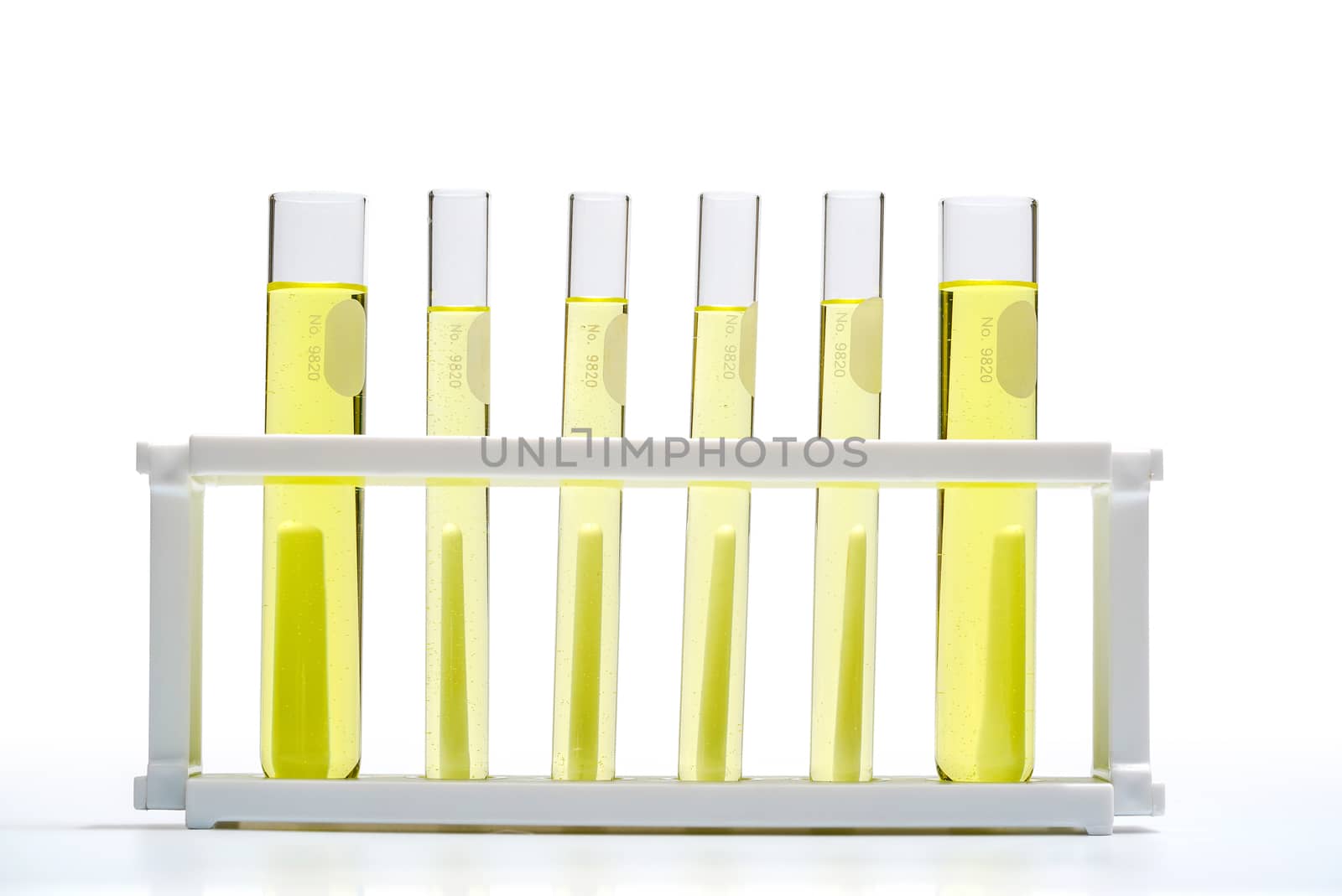 Yellow cosmetic color (oil). Chemicals for beauty care in test tube. Nickle chloride liquid, alcohol