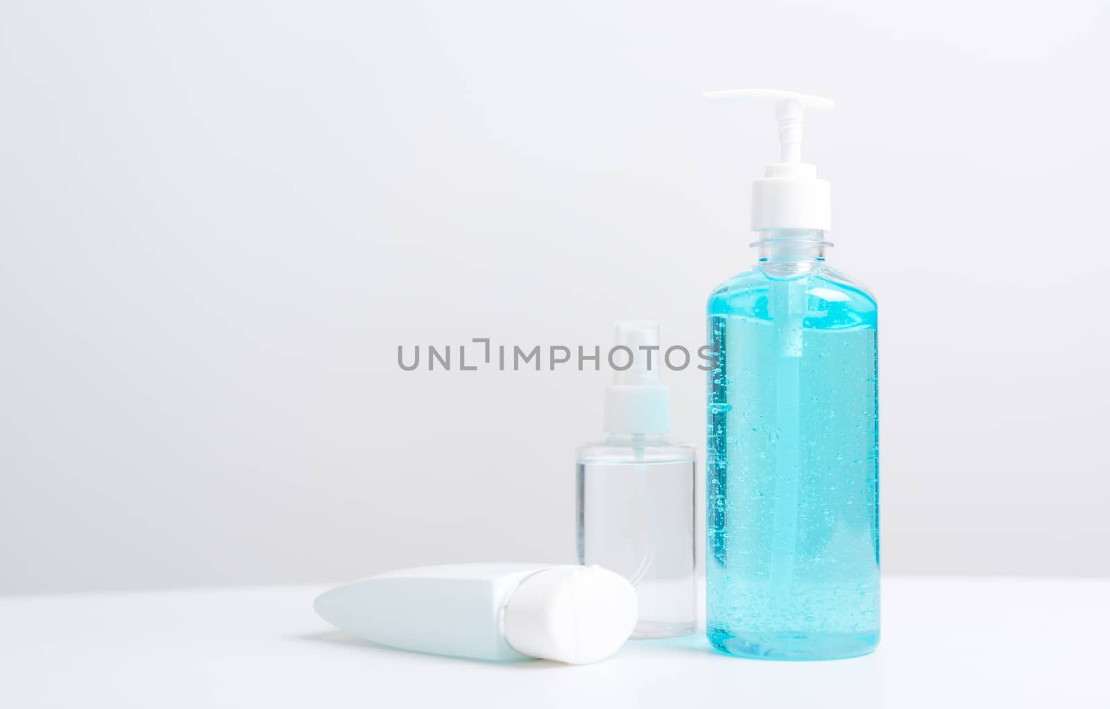 Plastic dispenser sanitizer alcohol gel pump and spray bottle for washing hand hygiene prevention of coronavirus virus studio shot on white background