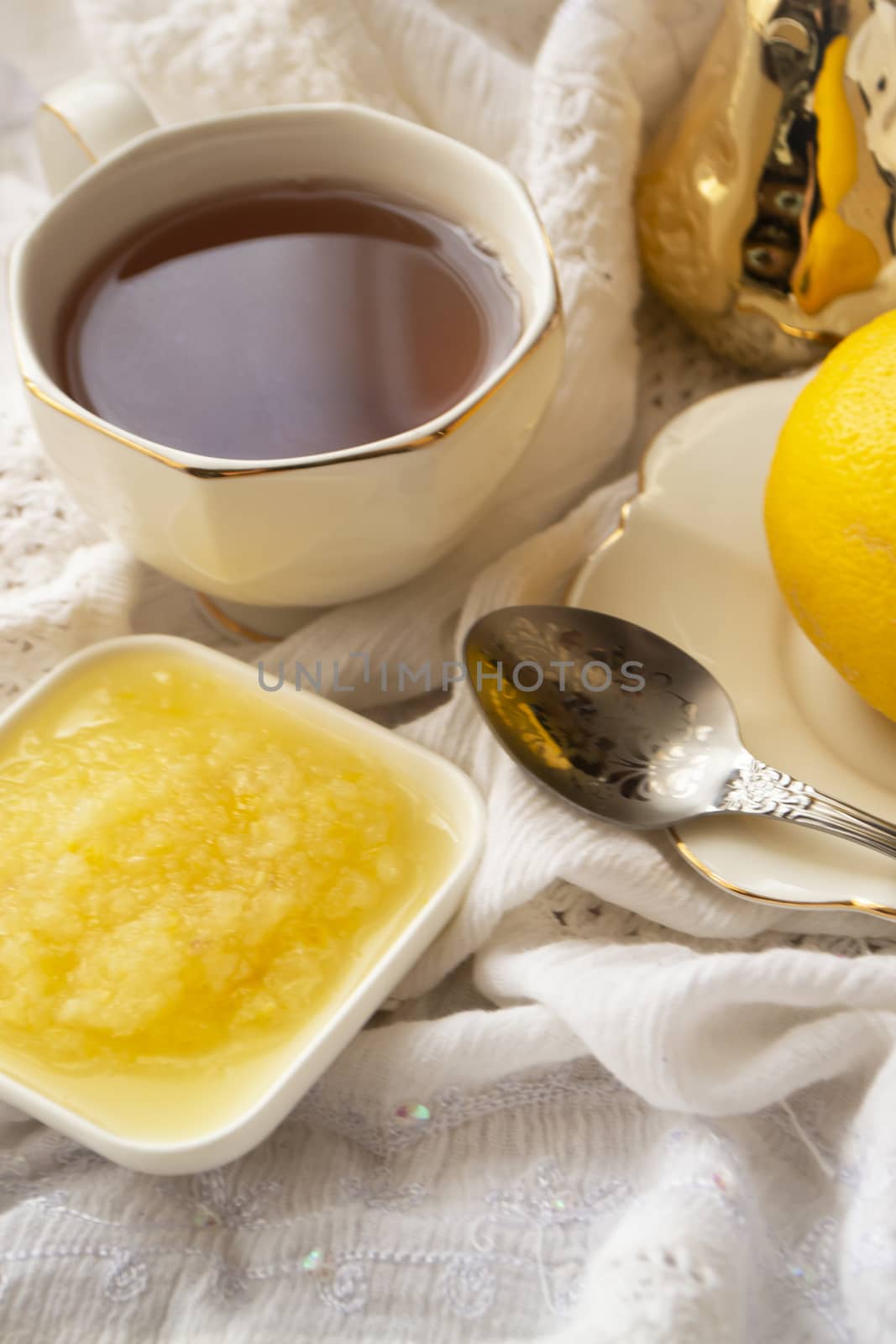 Lemon and green tea in white cup, fresh healthy detox tea, vertical image