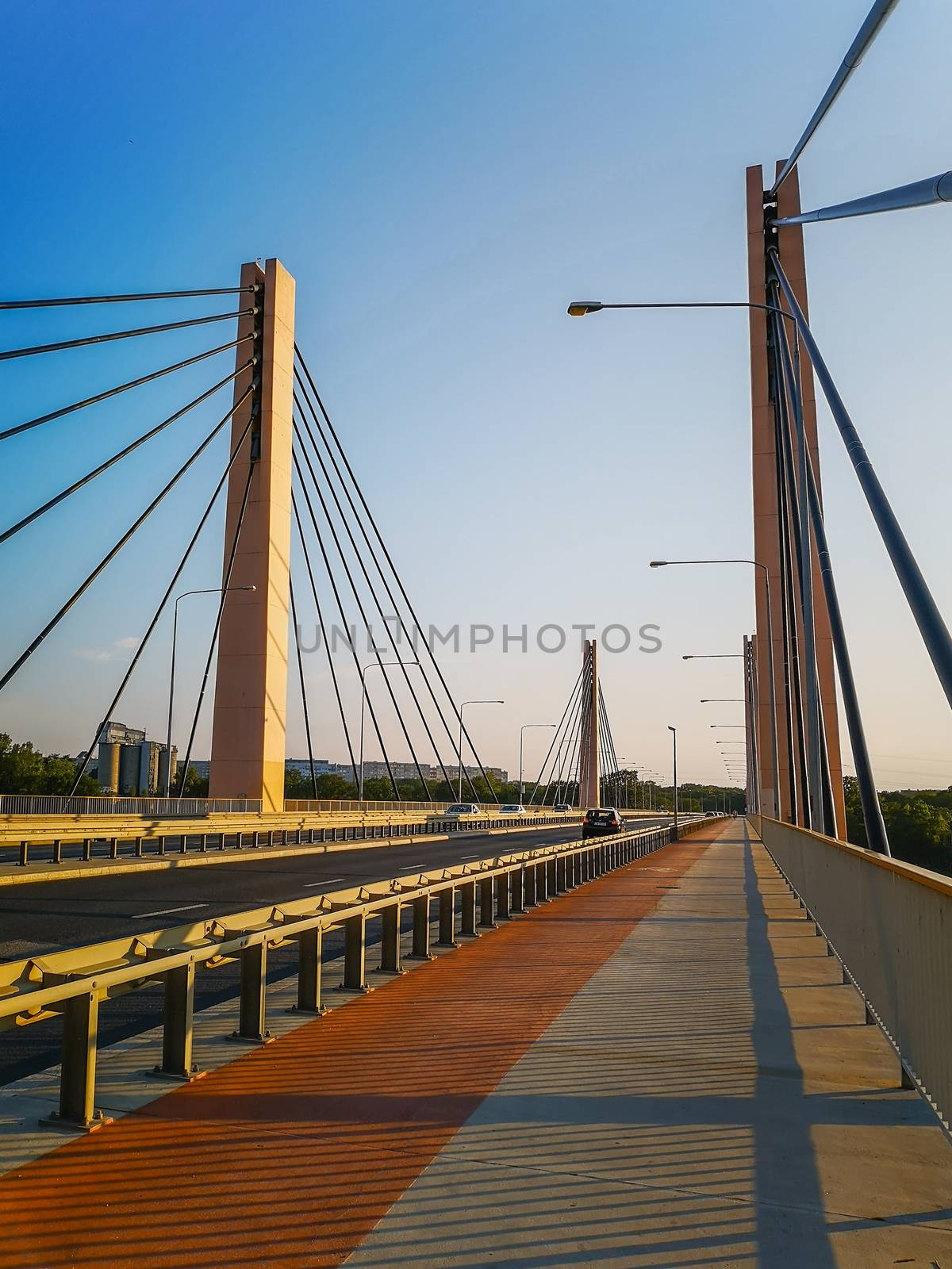 Red and gray pavement on huge Millennium bridge with large pillars in Wroclaw  by Wierzchu