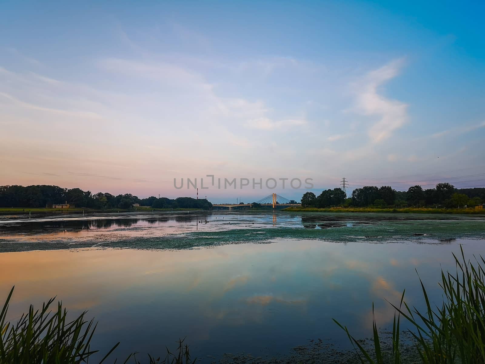 Landscape with colorful sky reflecting in river