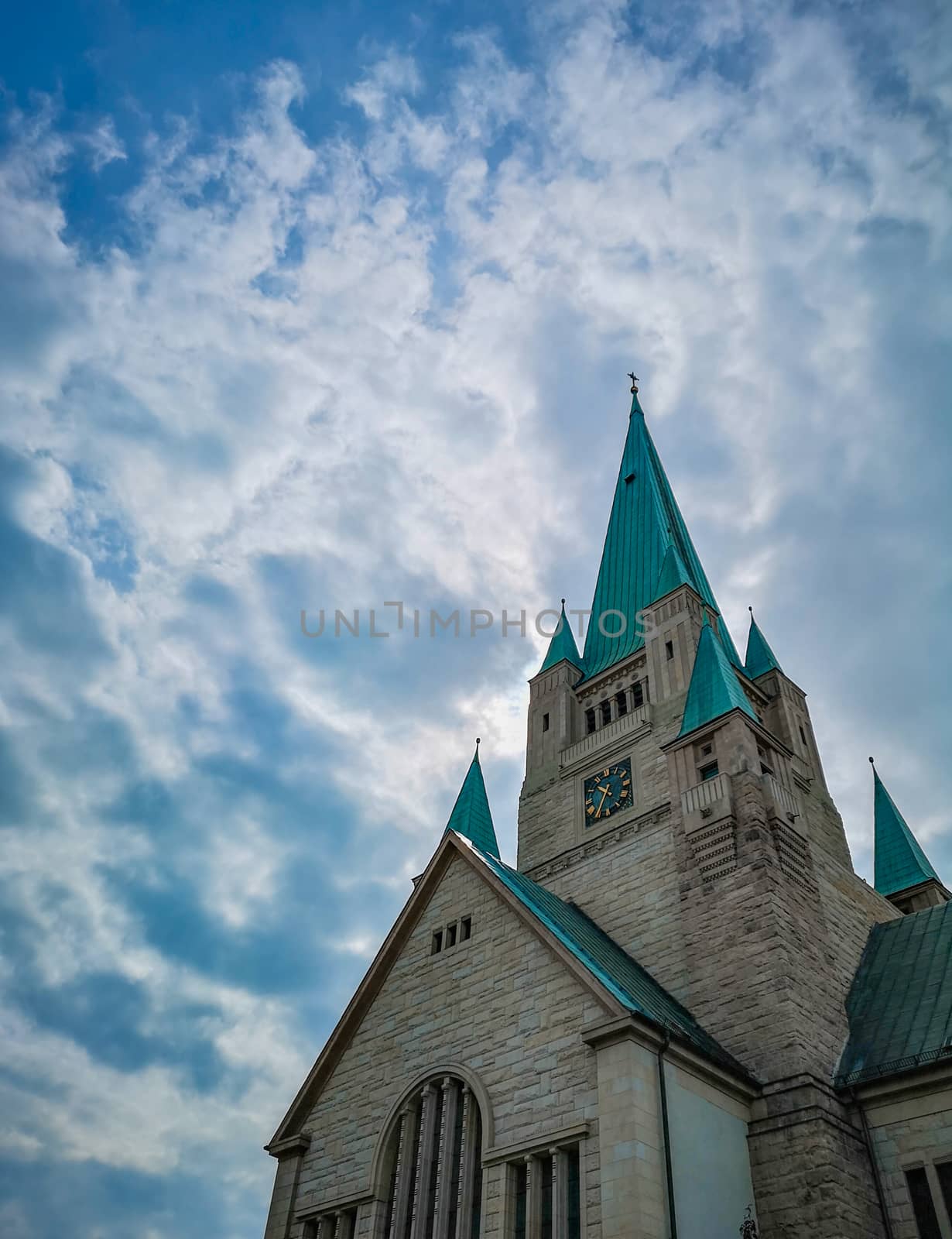 Tower of old Cathedral building in Wroclaw City with beautiful cloudy sky as background