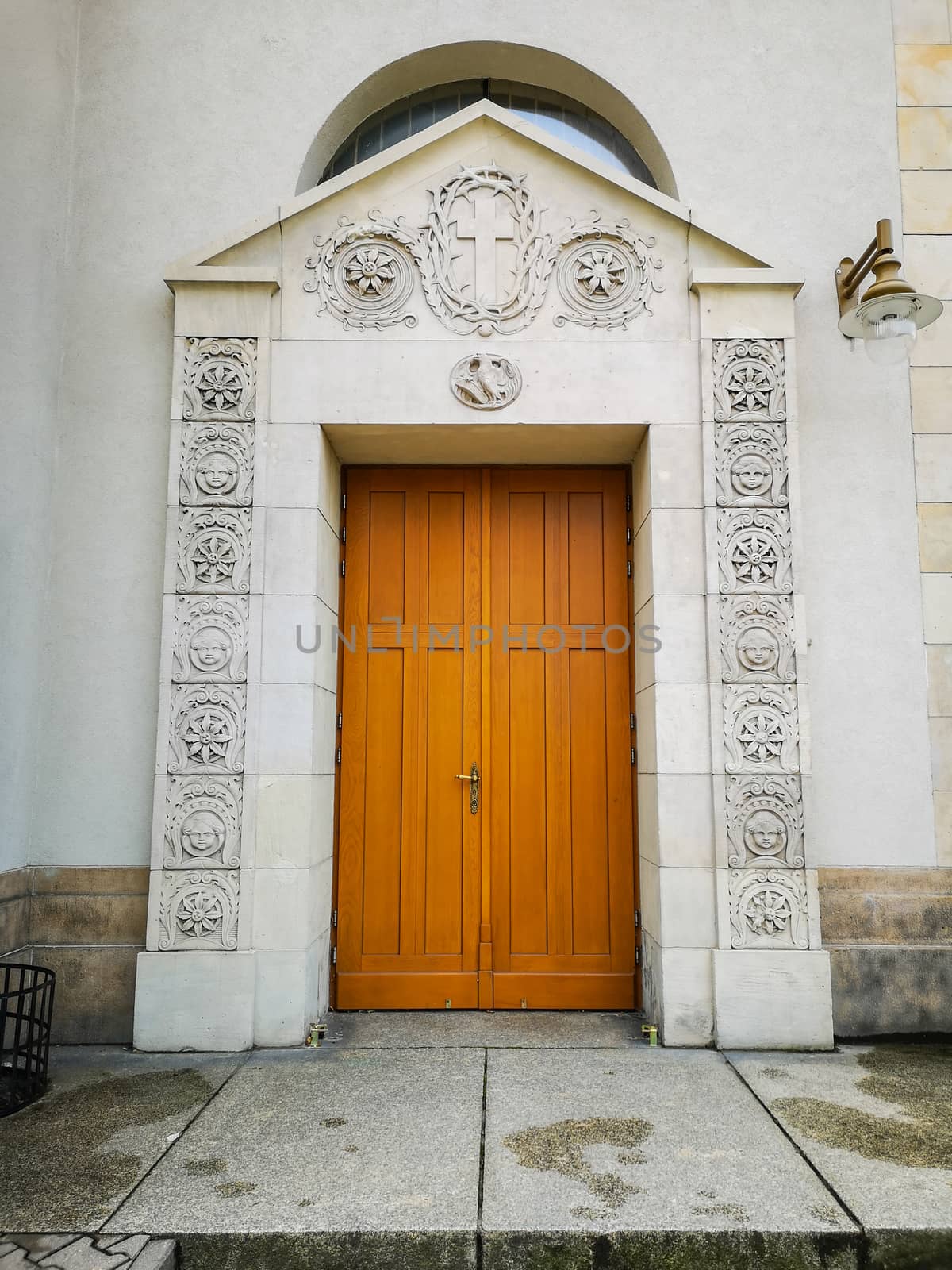 Huge wooden doors with white reliefs to cathedral by Wierzchu