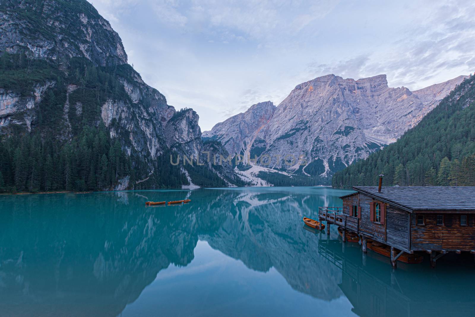 Mooring of boats on Lake Braies at first light in the morning by brambillasimone