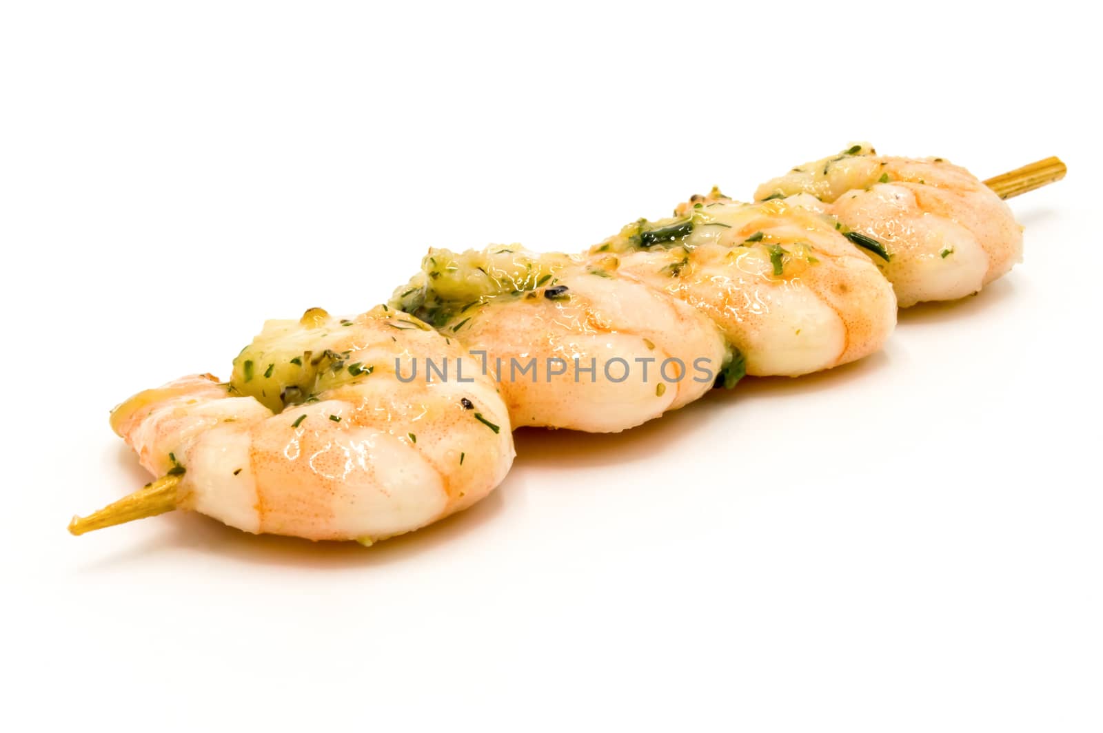 BBQ shrimp - Shrimp skewers ready to grill on a white plate / bottom.
