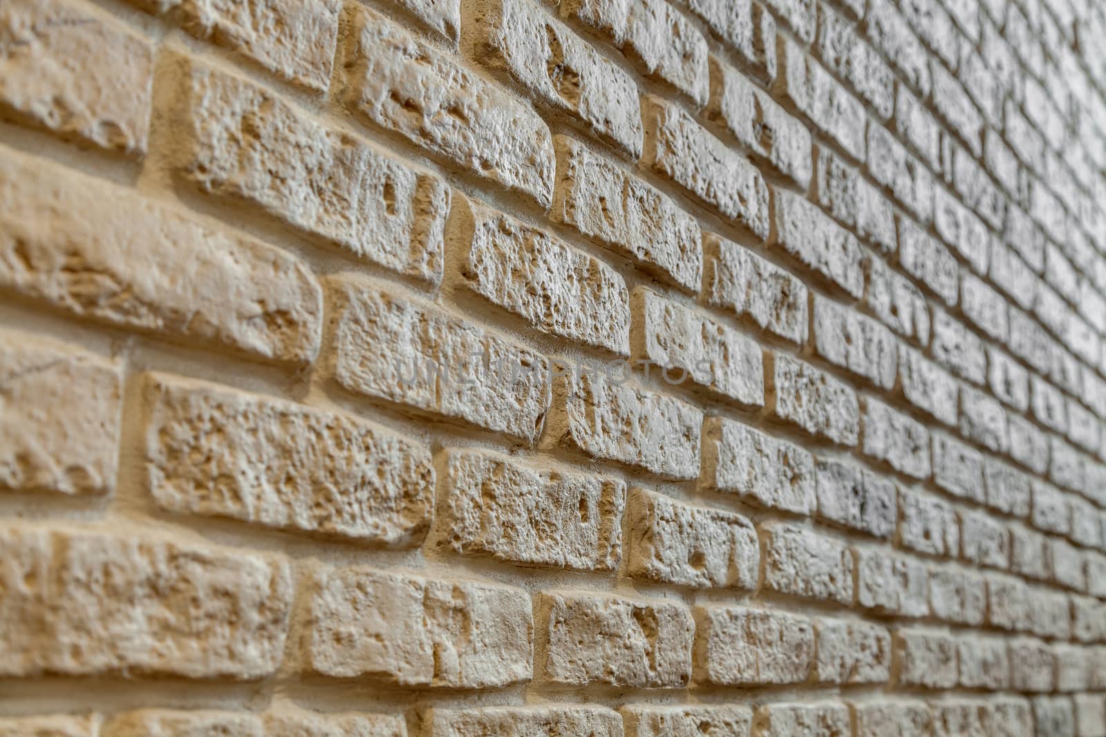 A fragment of the wall lined with white brick. Brick background.