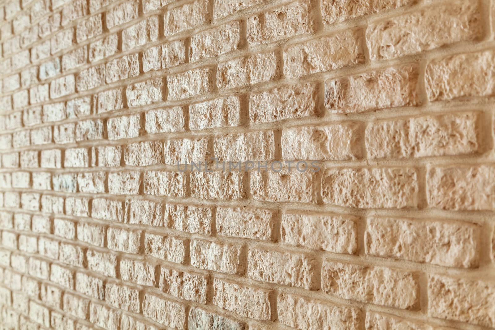 A fragment of the wall lined with white brick. Brick background.