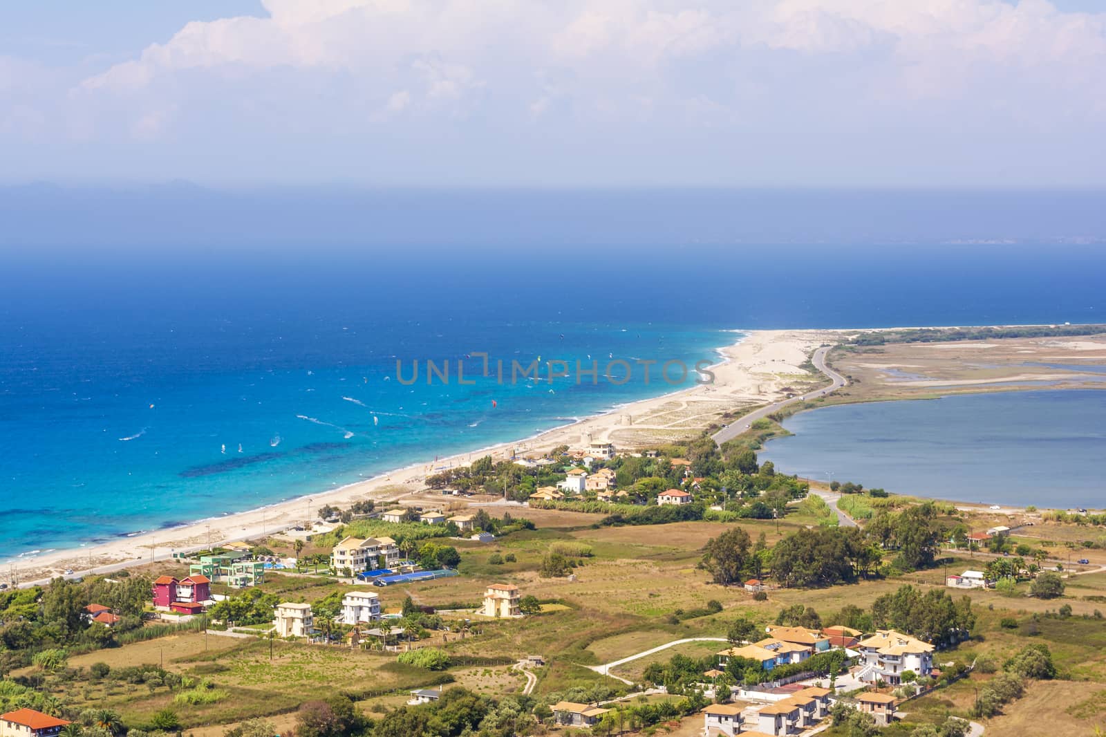 Ai Yiannis, Mili is a long sandy beach on the island of Lefkada, Greece. Preferred by wind and kite surfers. It covers a stretch of 4.5 km and the waters are turquoise coloured.