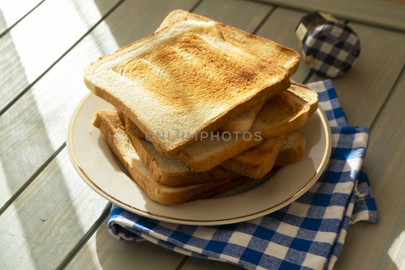 Wooden board with tasty breakfast bread toasts on table, country image