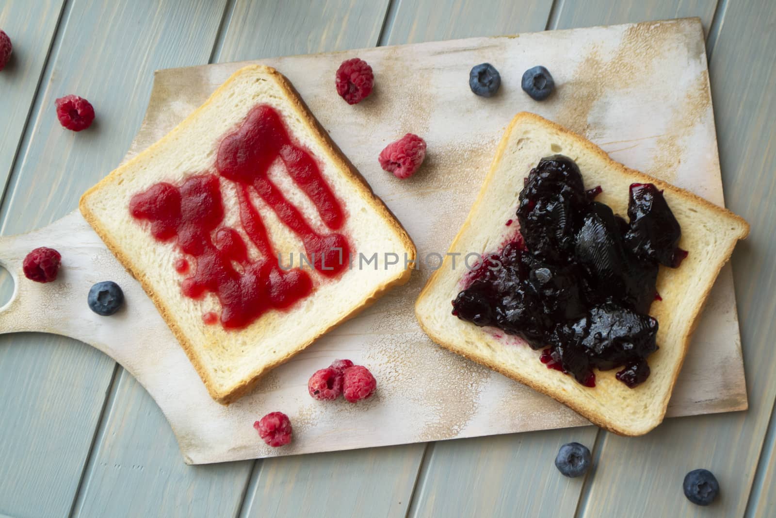 homemade confiture with fresh fruits from garden, rustic decoration. Fruit jam on toasted bread. Flat lay
