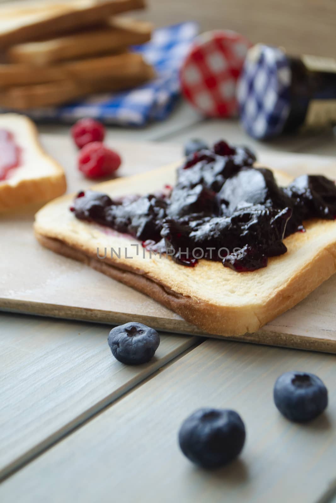 sweet blueberries jam on toast close up, vertical image