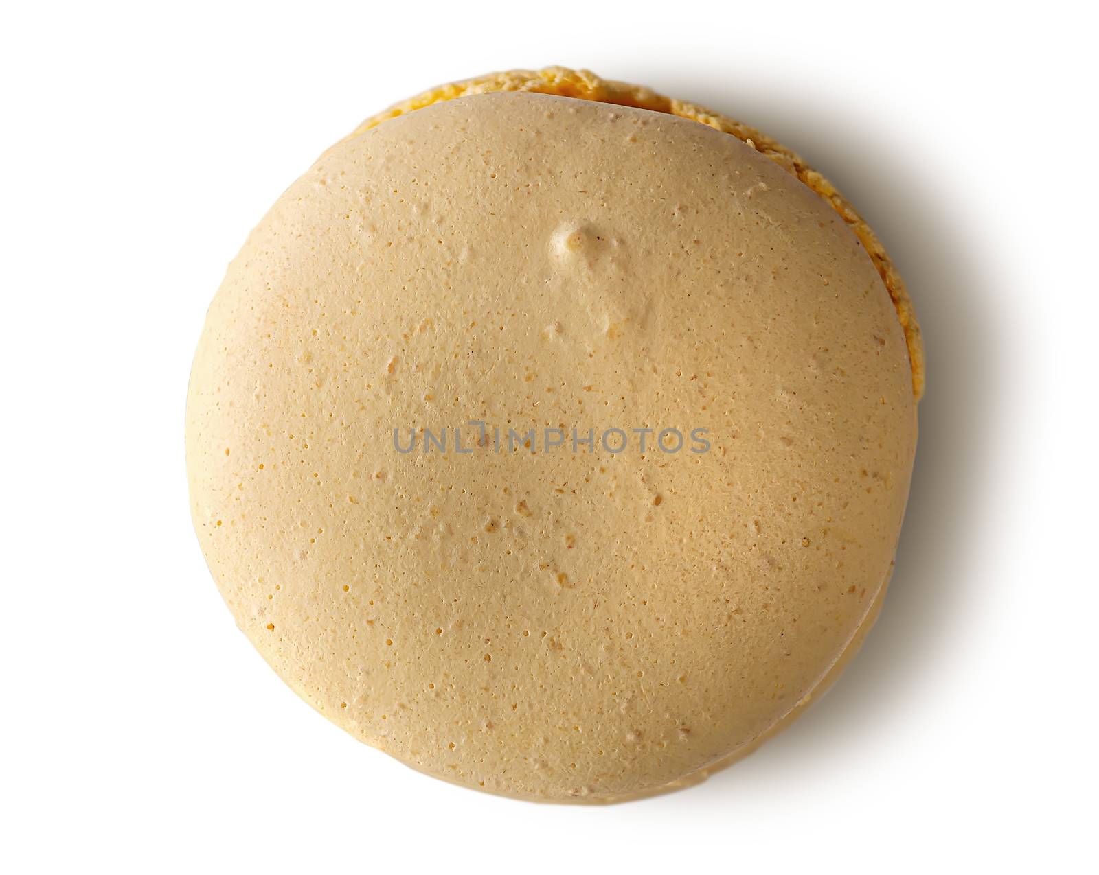 One yellow macaroon top view on white background