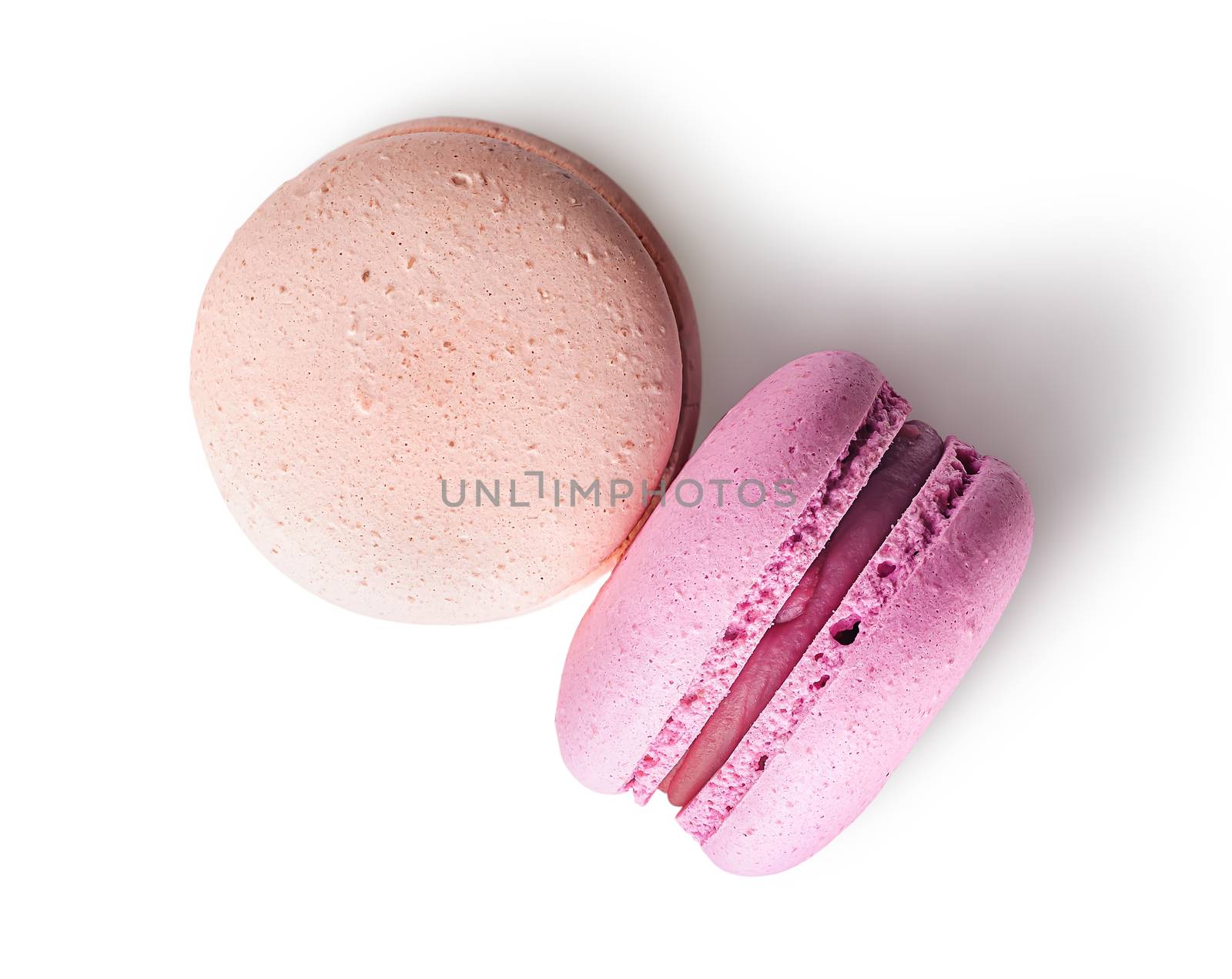Two macaroon beige pink top view on white background