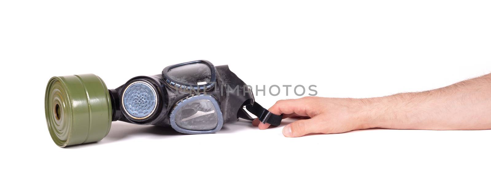 Arm reaching for vintage gasmask isolated on a white background - Green filter