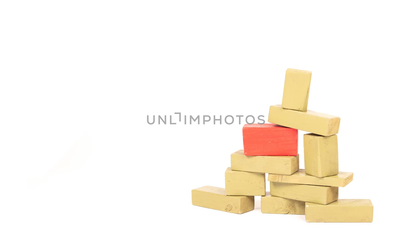 Vintage green building blocks isolated on white background, one standing out