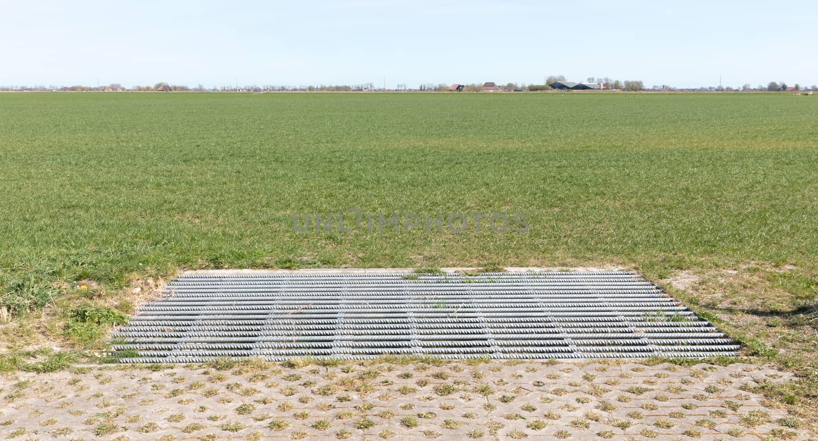 Cattle grid in ground, an obstacle used to prevent wild cattle and other wildlife from crossing