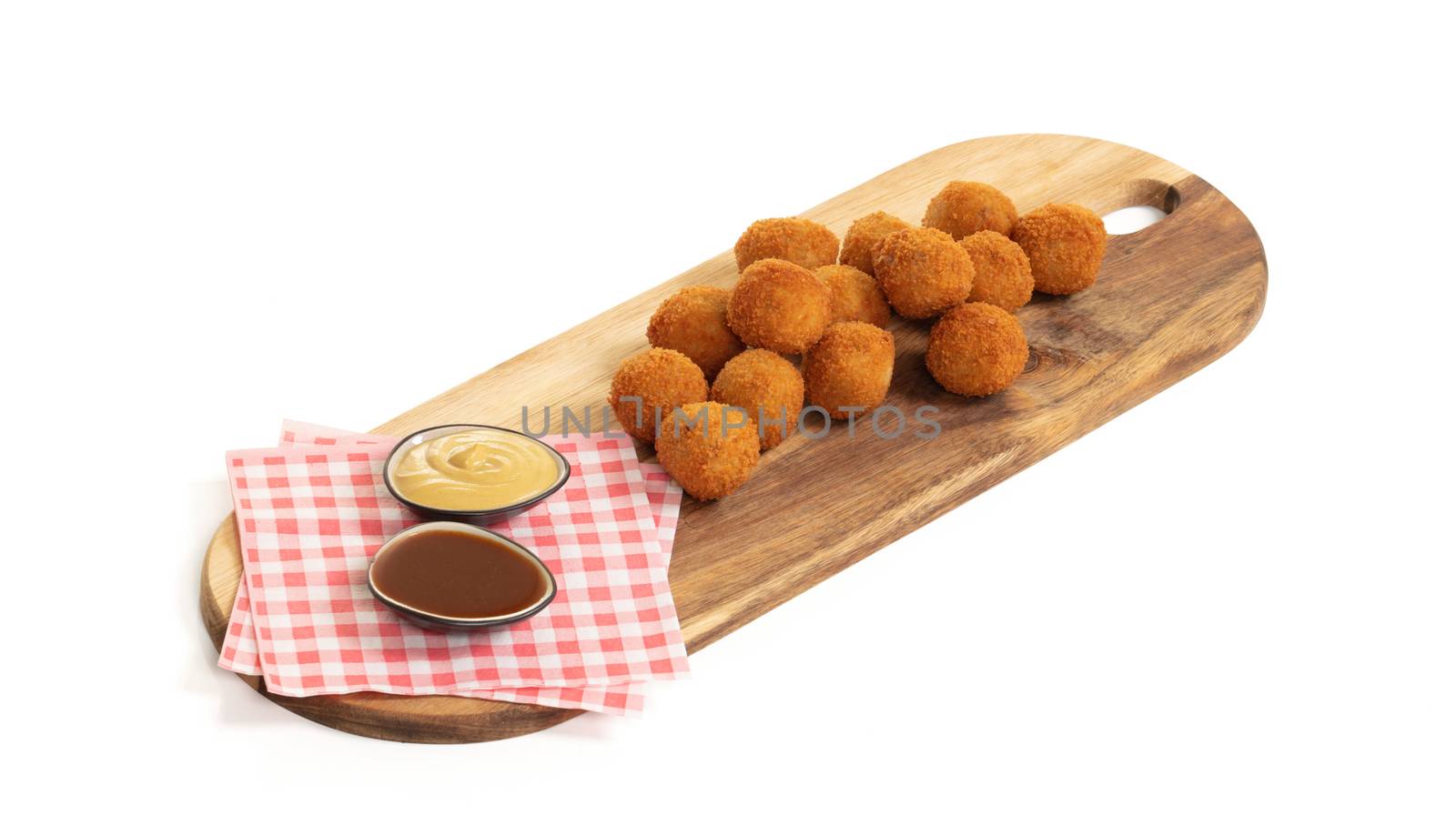 Dutch traditional snack bitterbal on a serving board by michaklootwijk