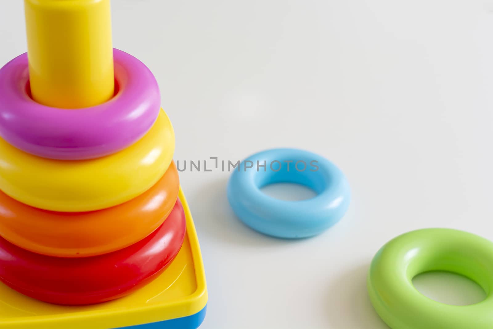Colorful plastic rings stacked in a tower. Toy for newborns.