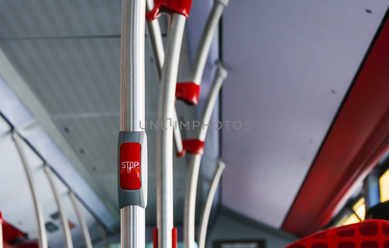 red button to book the stop in a public bus. Public transportation concept