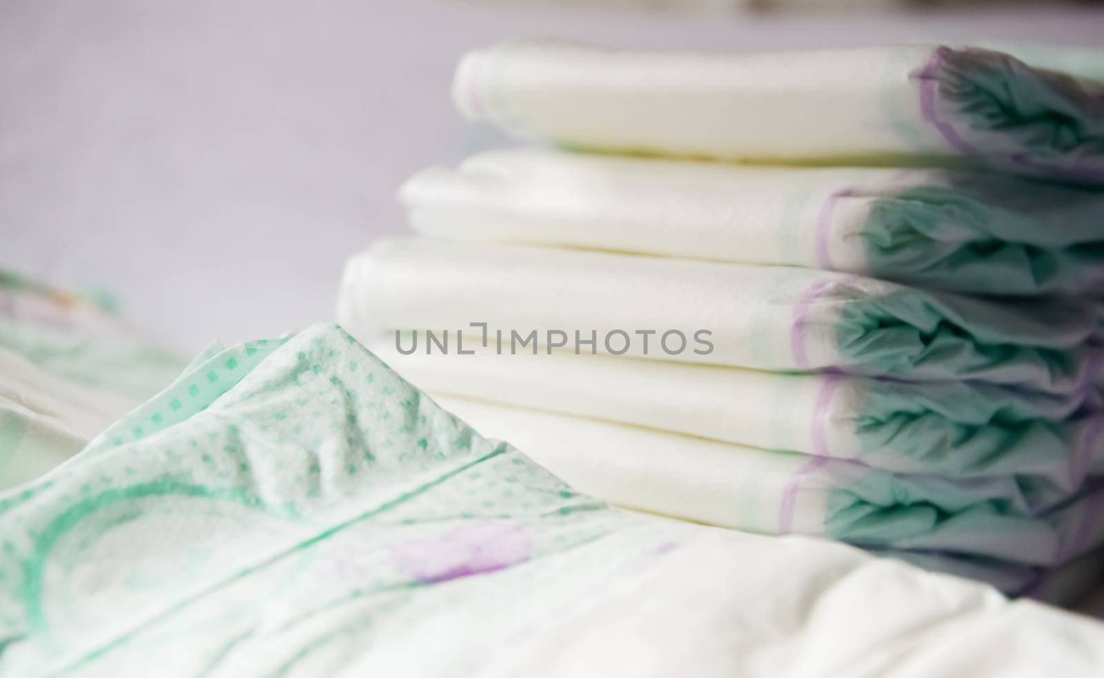 close-up view of a group of folded white diapers ready to be used. Health care of the newborn by rarrarorro