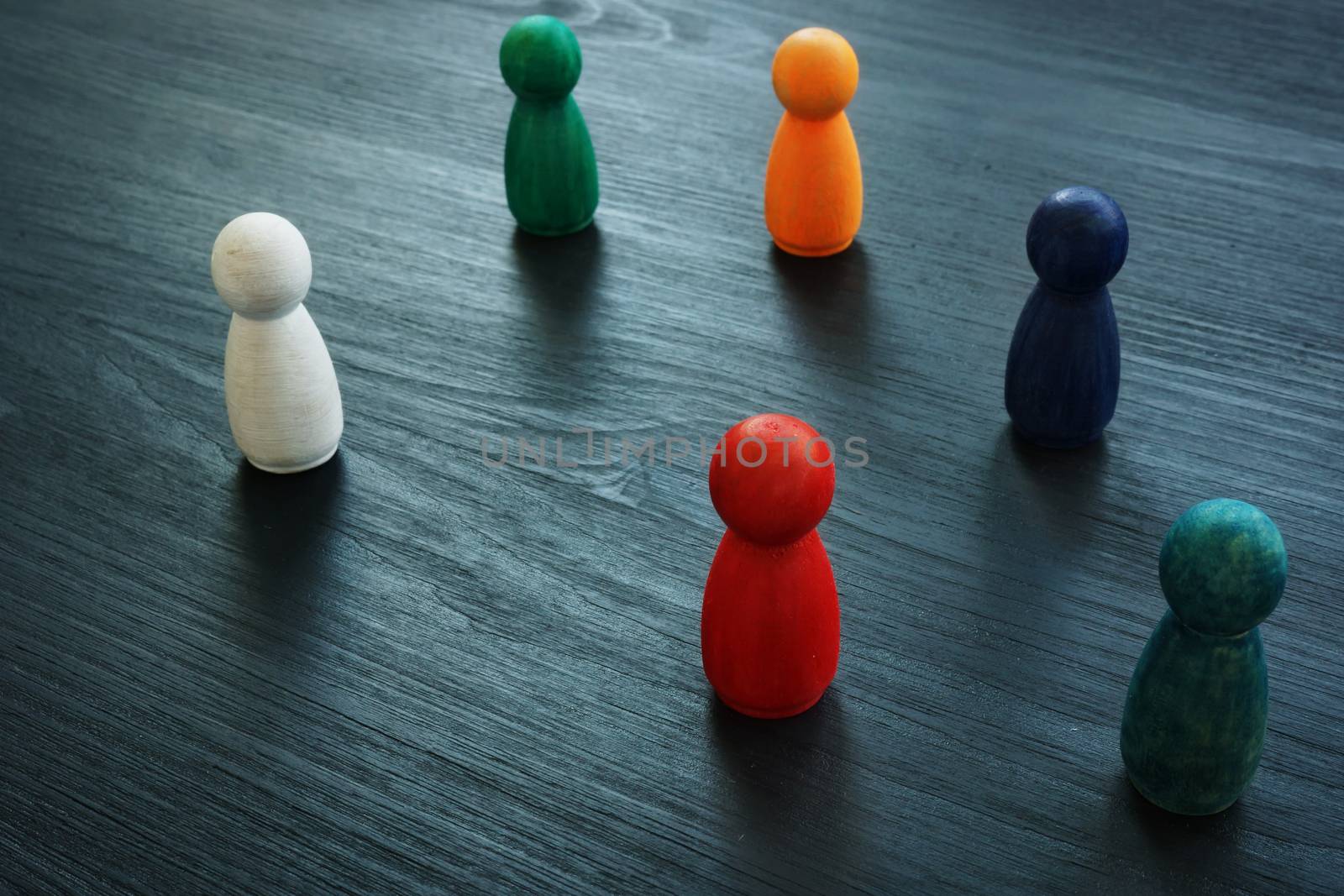 Diversity and inclusion for business concept. Colored figurines on the desk. by designer491