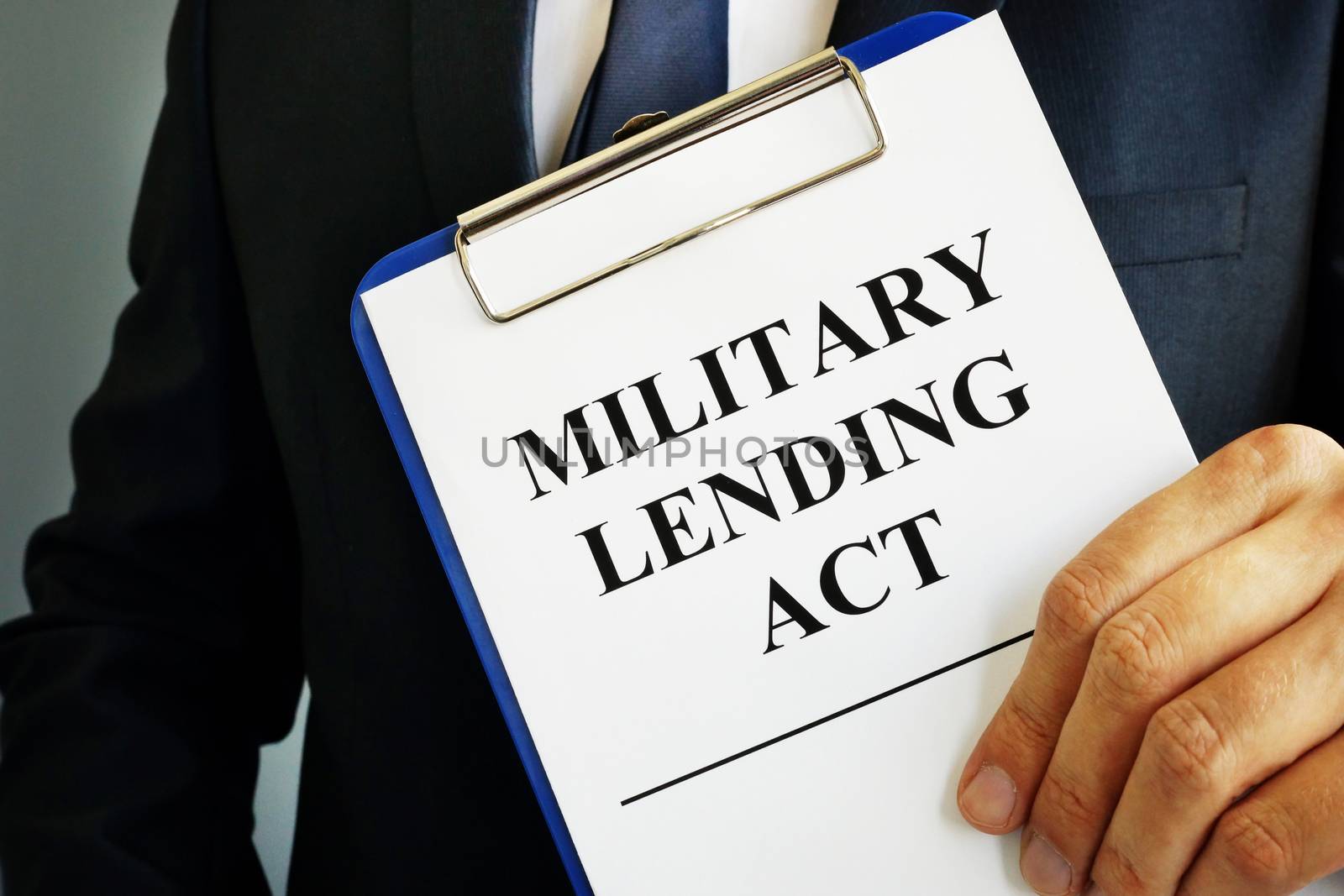 Man is holding Military Lending Act MLA.