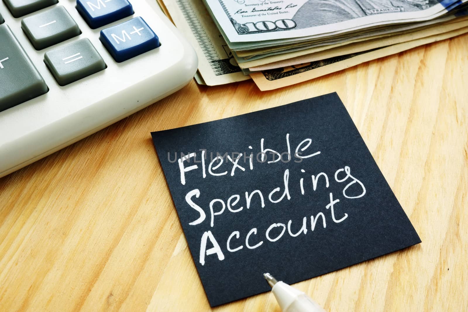 Flexible spending account FSA sign on a black piece of paper. by designer491