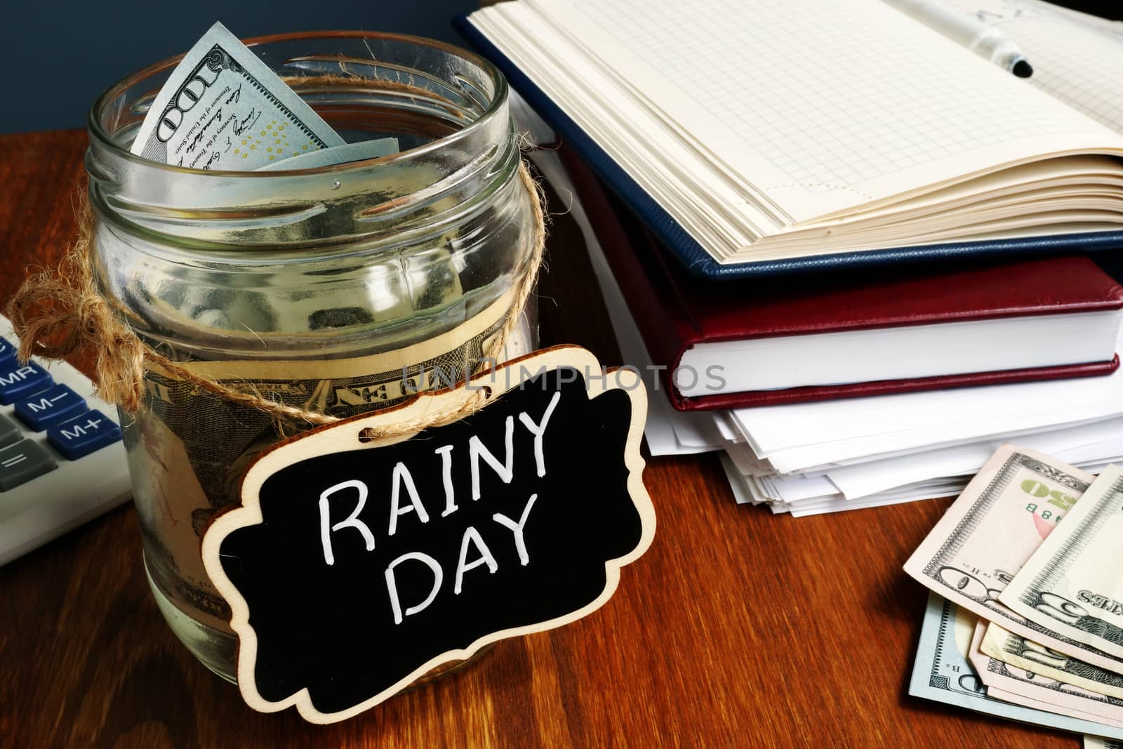 Rainy Day Fund label on the jar with money. by designer491