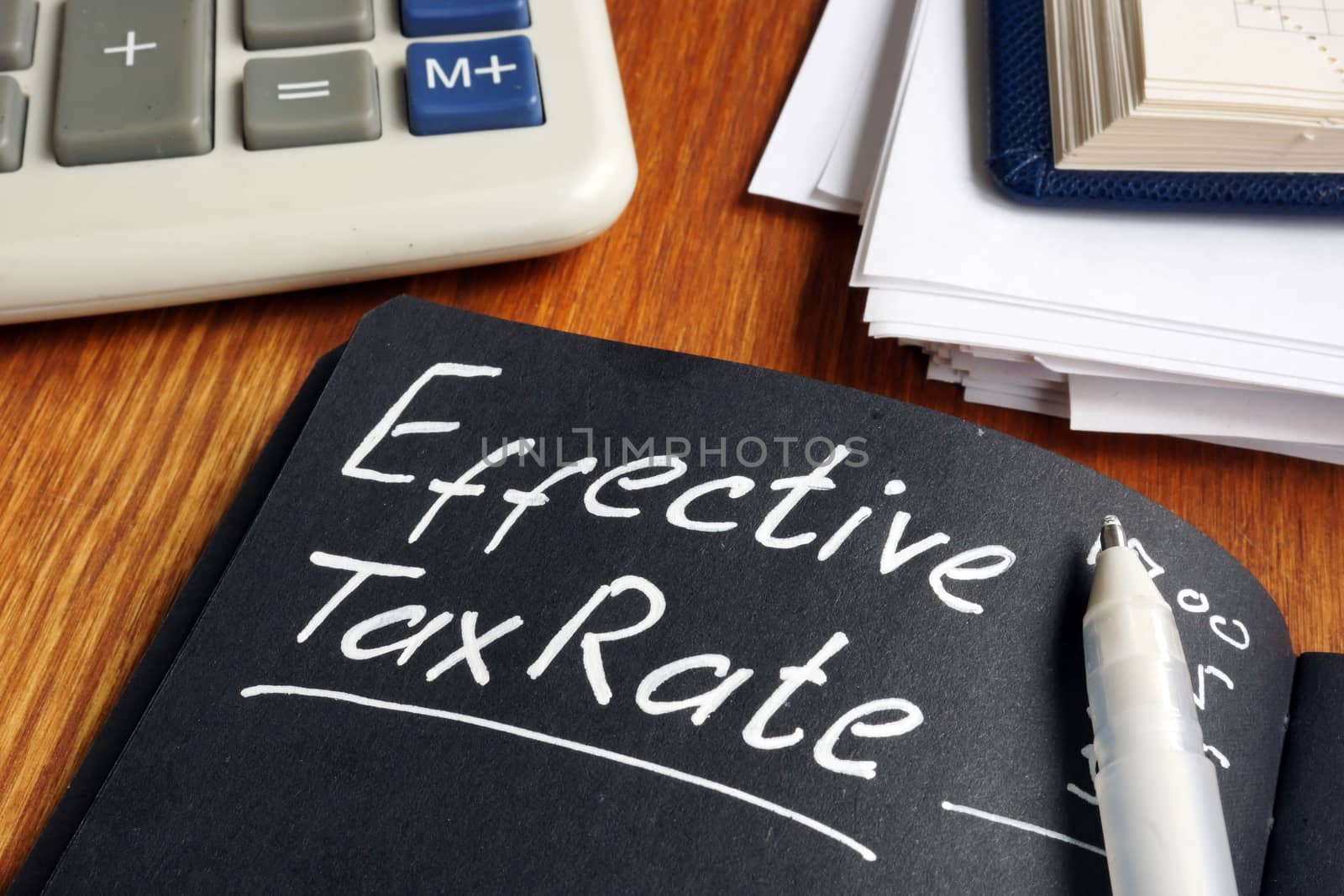 Effective Tax Rate concept. Stack of papers on a desk.