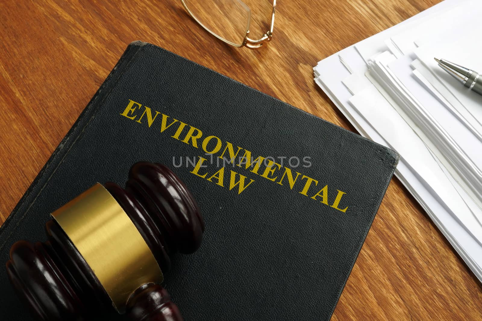 Environmental law book with stack of papers. by designer491