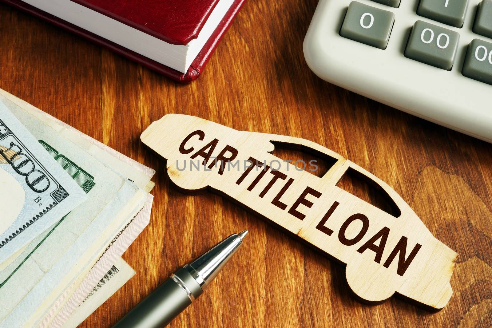 Car title loan concept. Wooden model of vehicle and money.