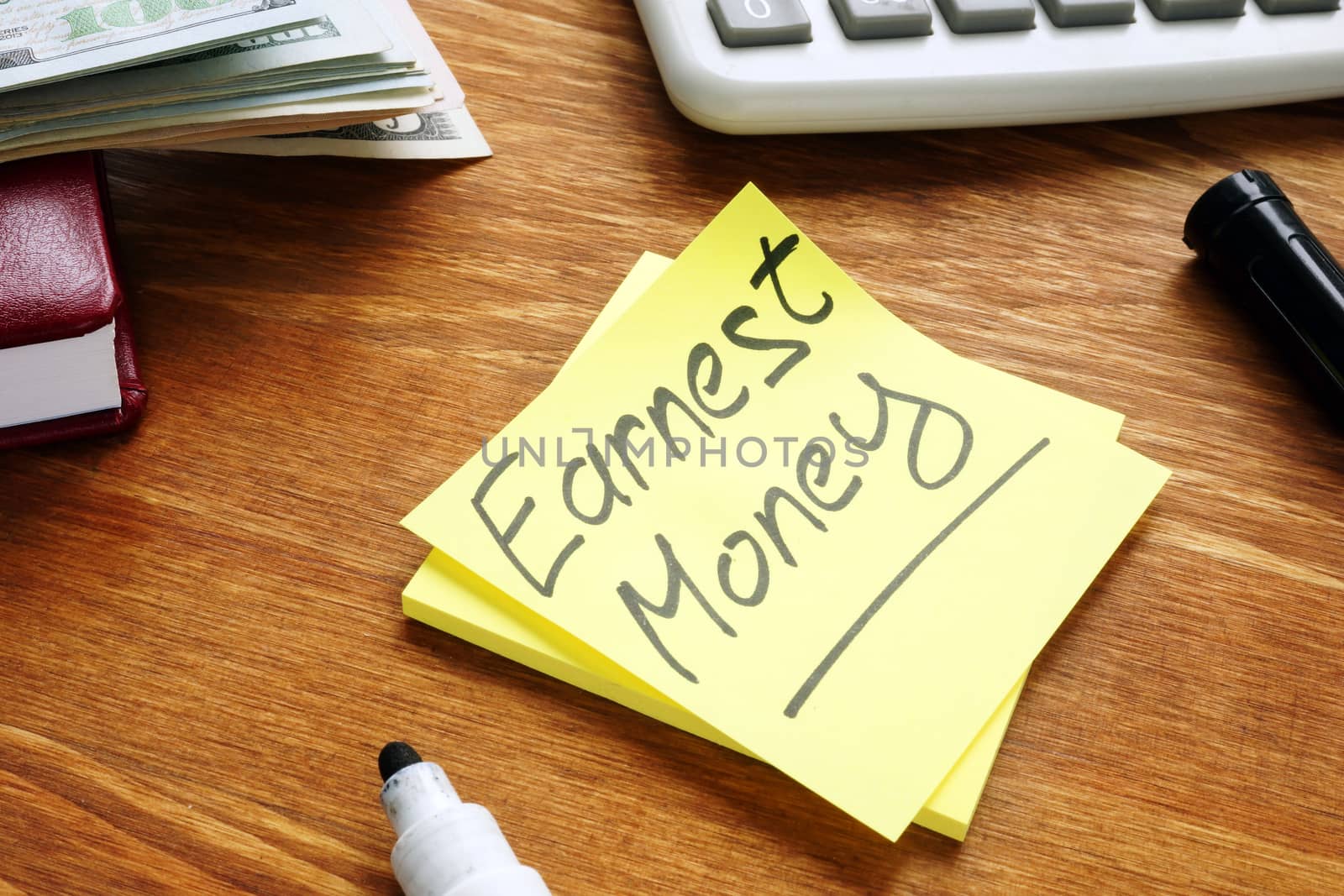 Earnest Money handwritten inscription, cash and calculator.