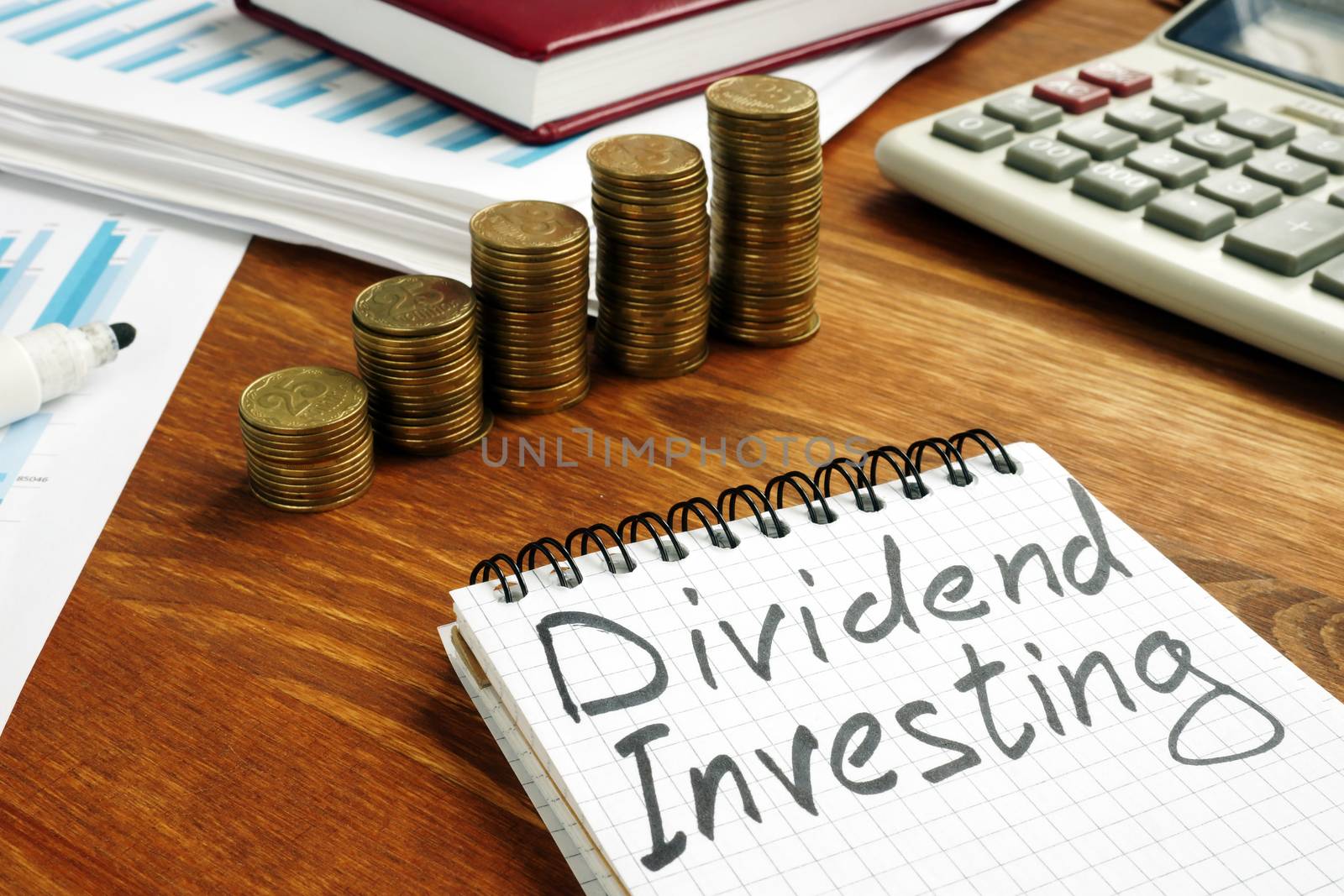 Dividend Investing sign and stacks of money.