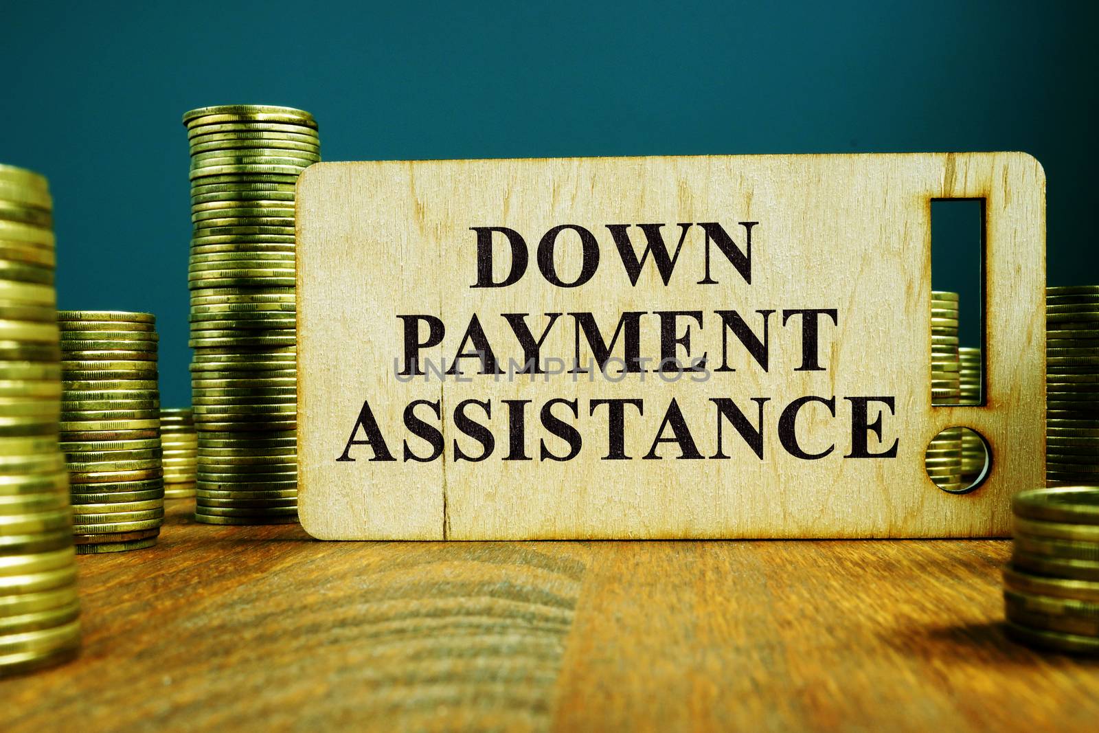 Down Payment Assistance sign on a wooden plate.