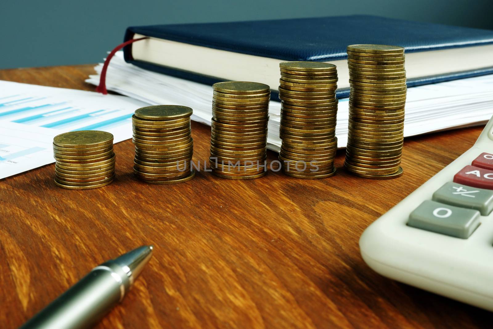 Increasing stacks of coins. Financial and business savings growth concept.