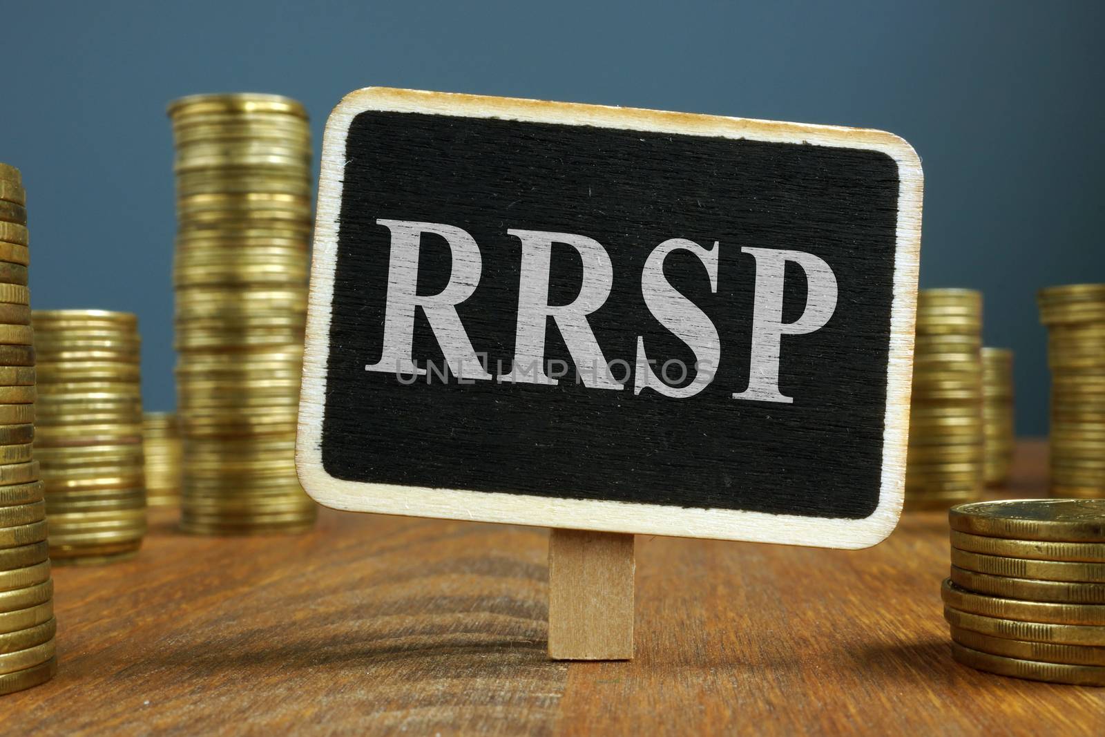 RRSP Registered Retirement Saving Plan and stacks of coins. by designer491