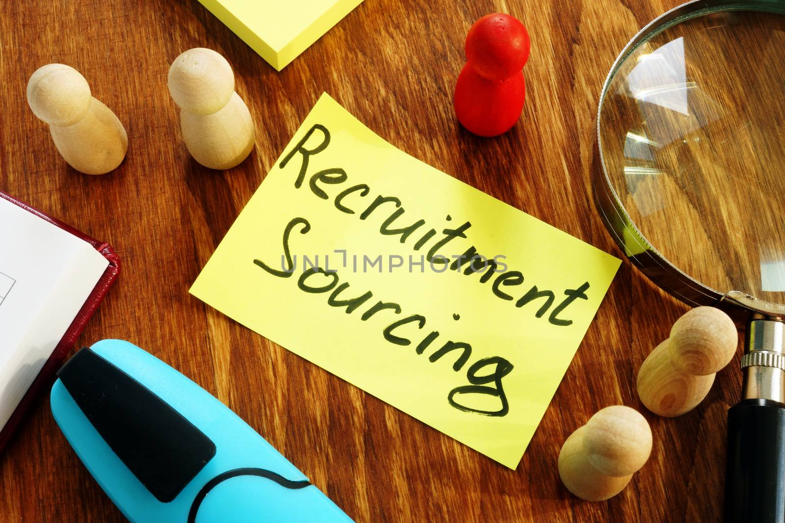 Recruitment Sourcing sign and magnifying glass on desk. by designer491