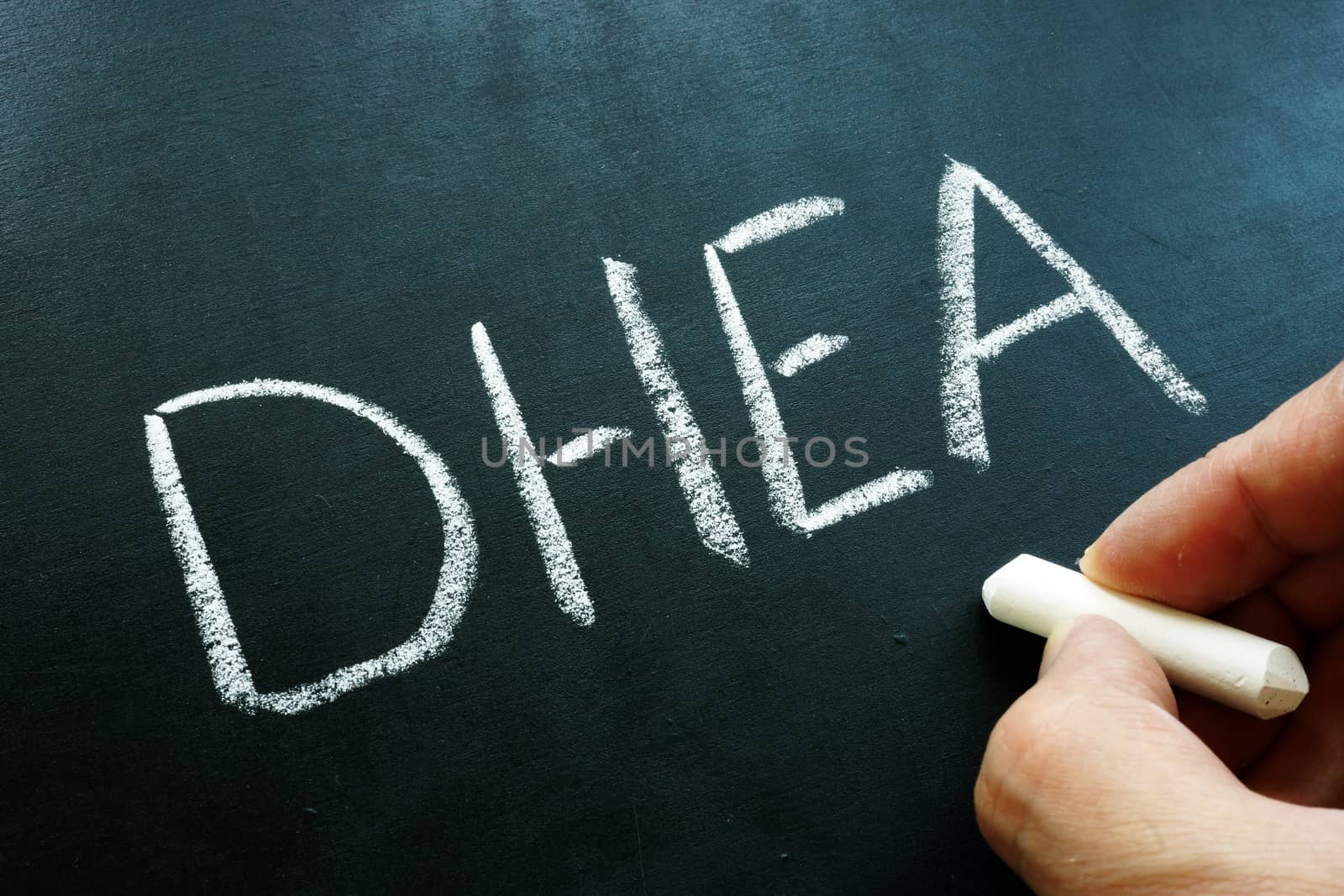 Dehydroepiandrosterone DHEA hormone and formula on the blackboard.