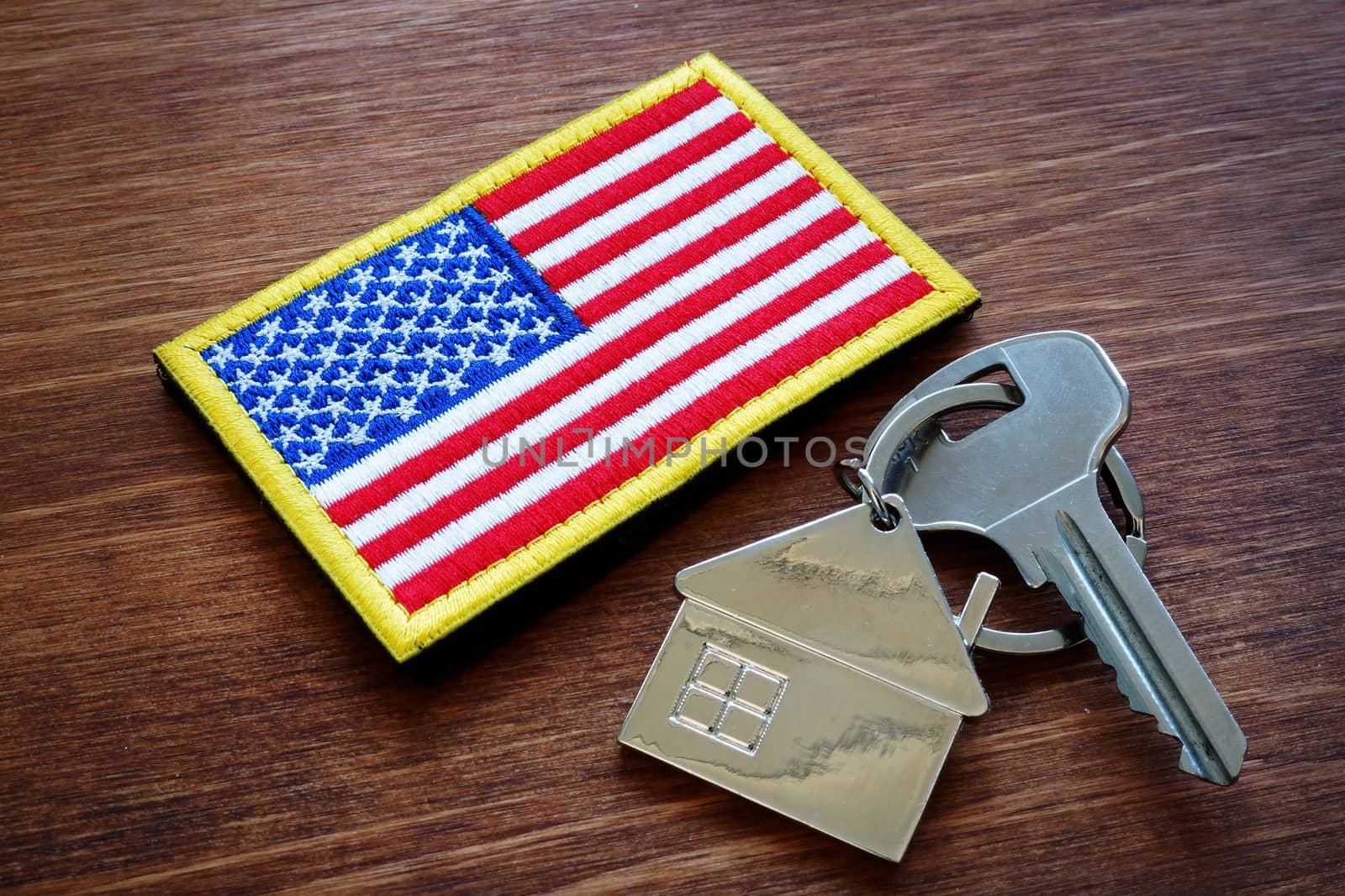 Key from property and USA flag. VA loan mortgage concept. by designer491