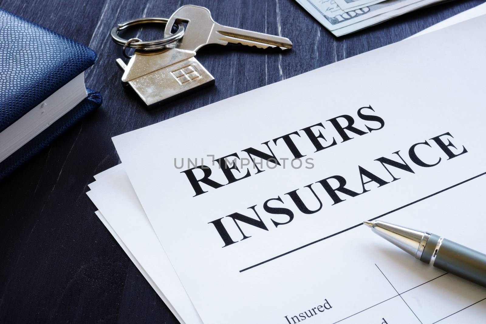 Renters Insurance policy agreement and key from apartments. by designer491