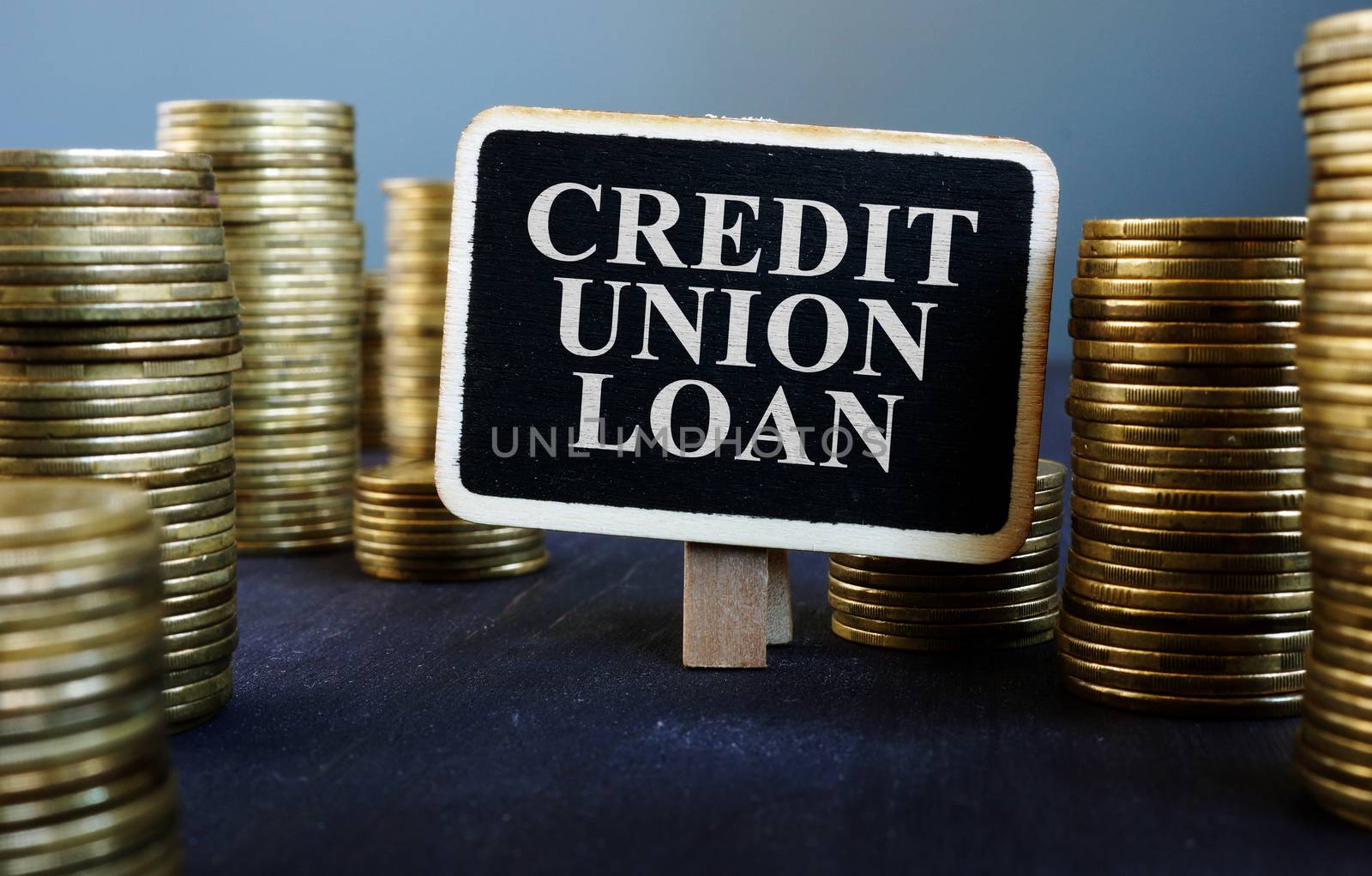 Credit union loan sign on wooden plate and money. by designer491