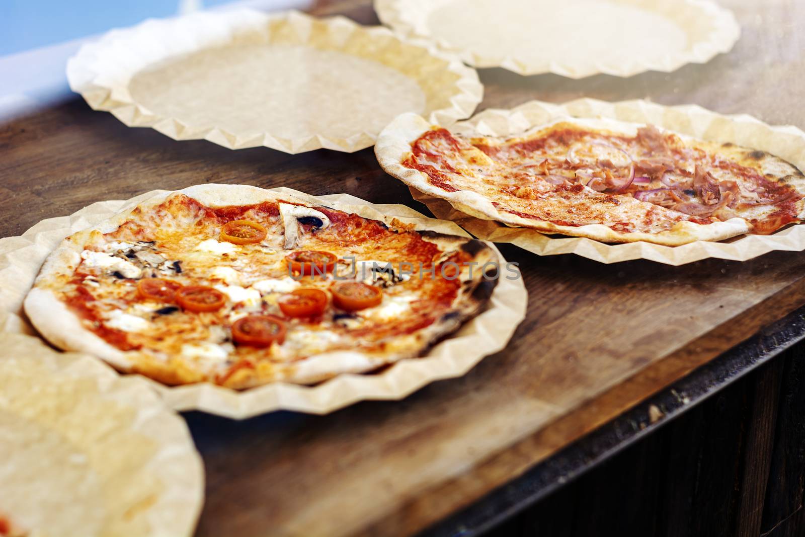 Freshly baked margherita pizza topped with tomato sauce, mozzarella and mushrooms. Typical recipe of Italian cuisine