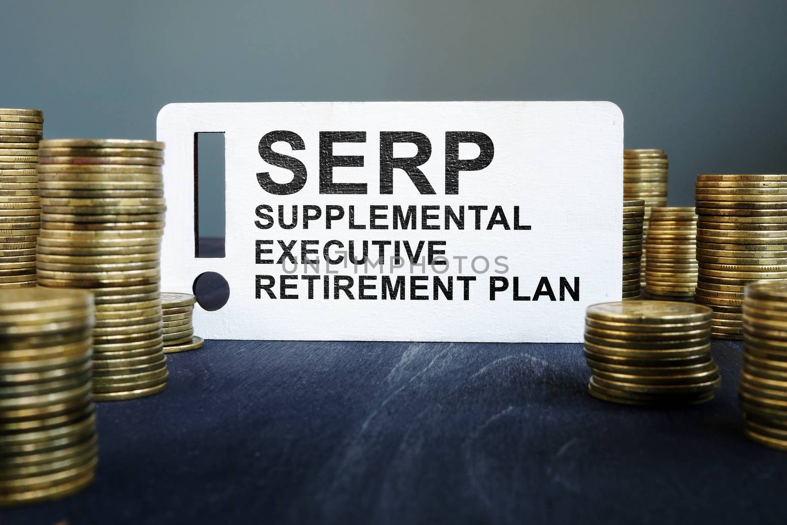 Supplemental Executive Retirement Plan SERP and stack of coins.